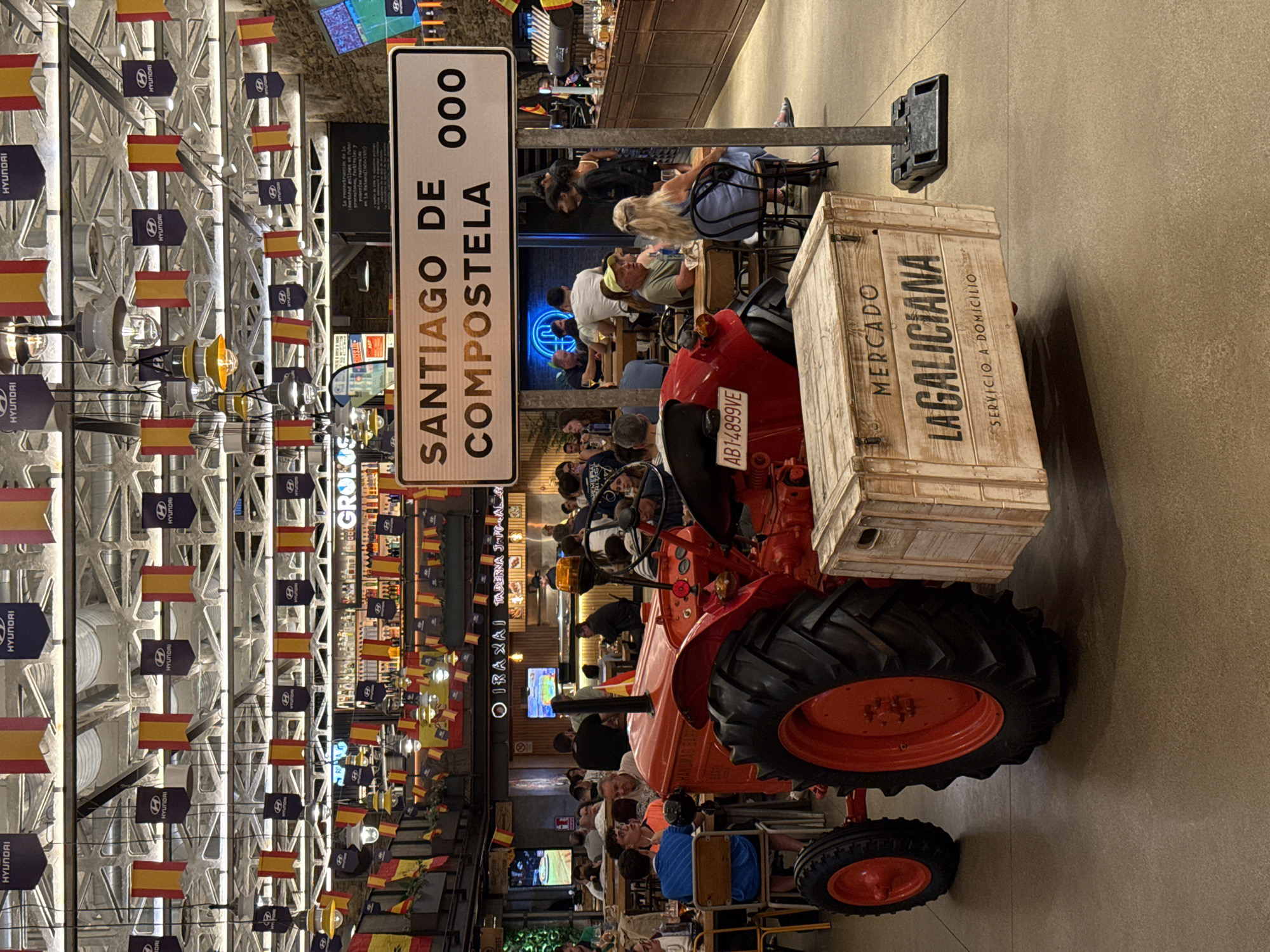 Red tractor and market signage inside Santiago de Compostela