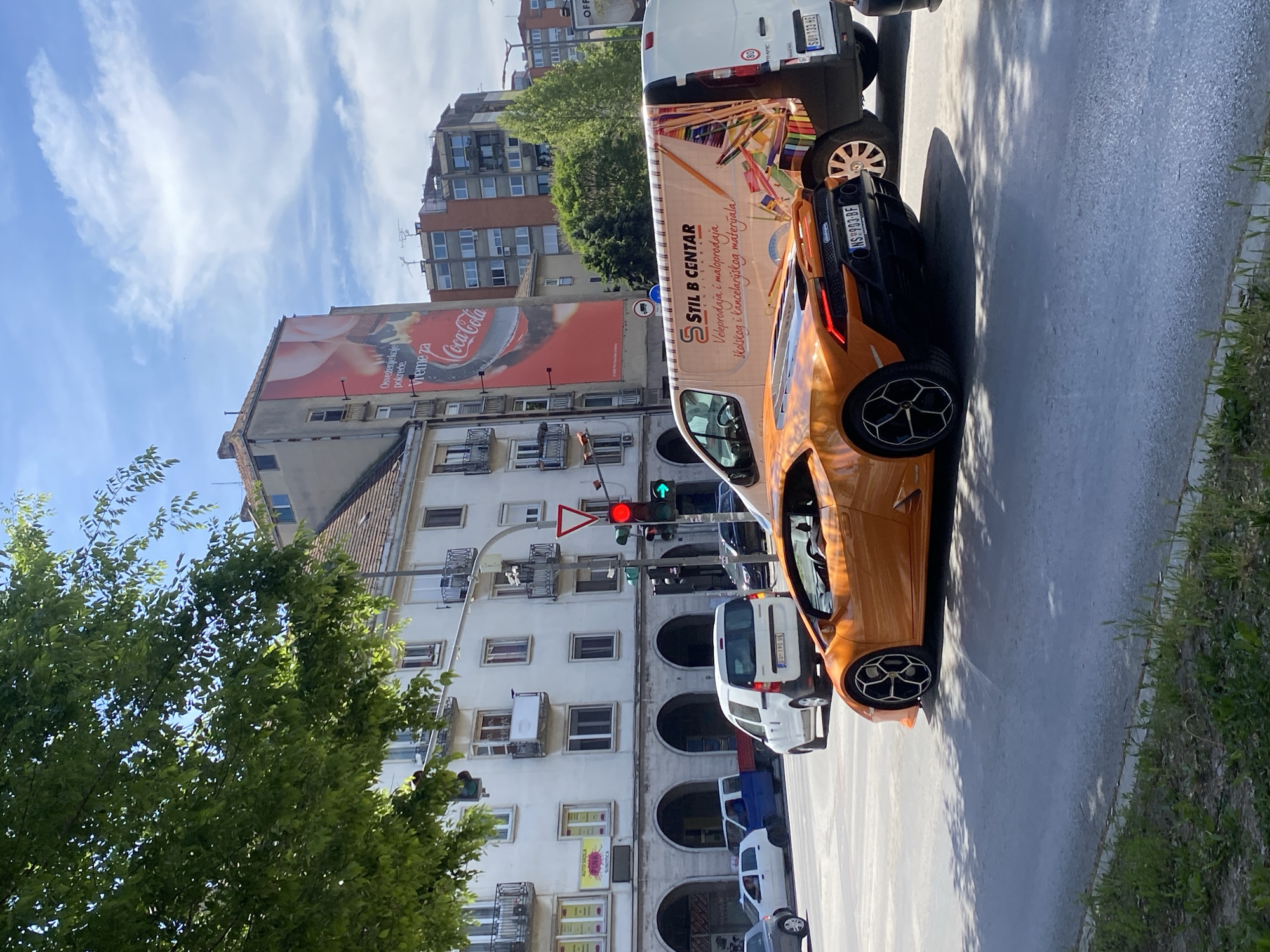 Orange Lamborghini spotted on Subotica street near advertising van