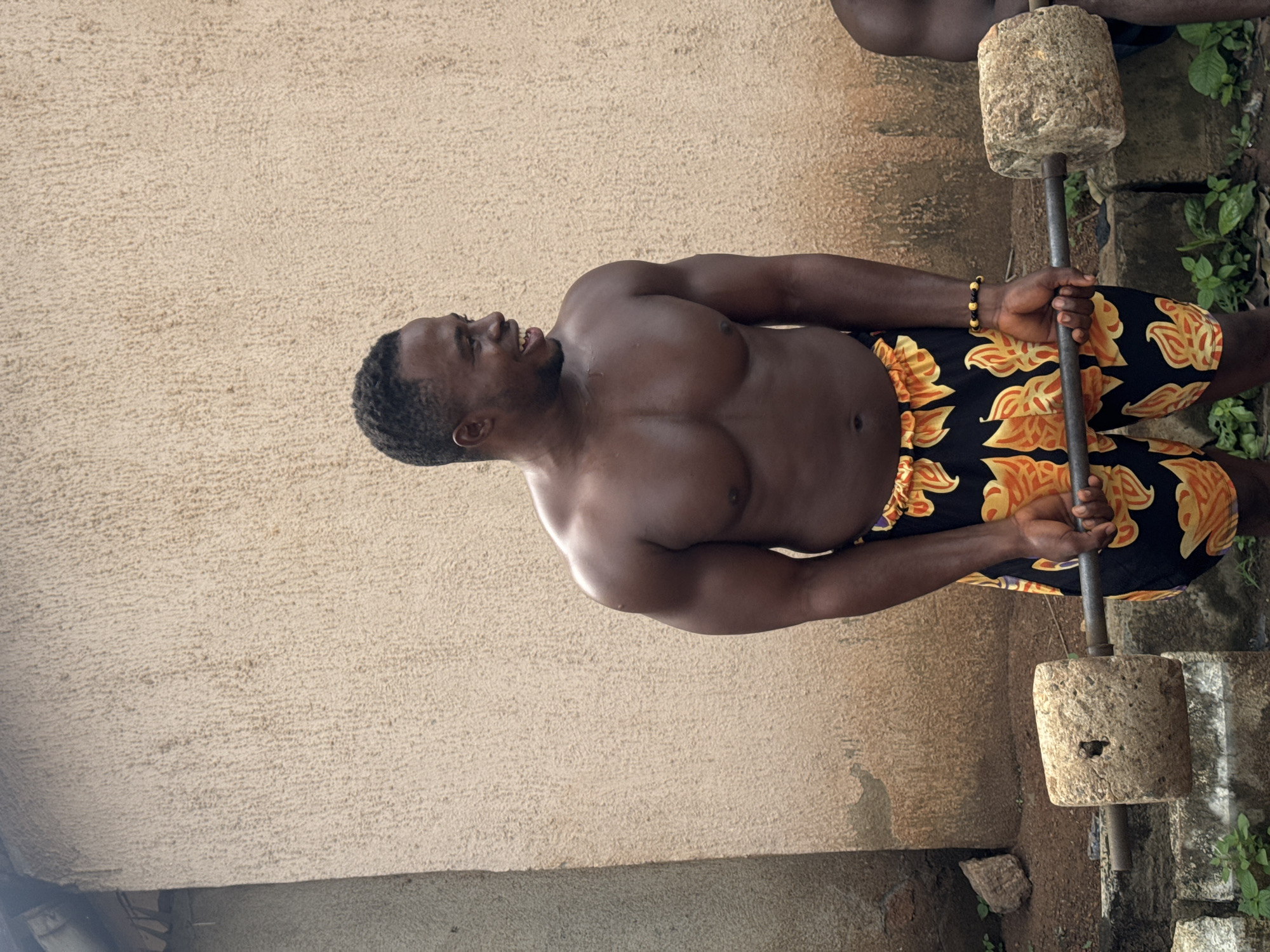 Outdoor weightlifting with stone barbells in Akwanga, Nigeria