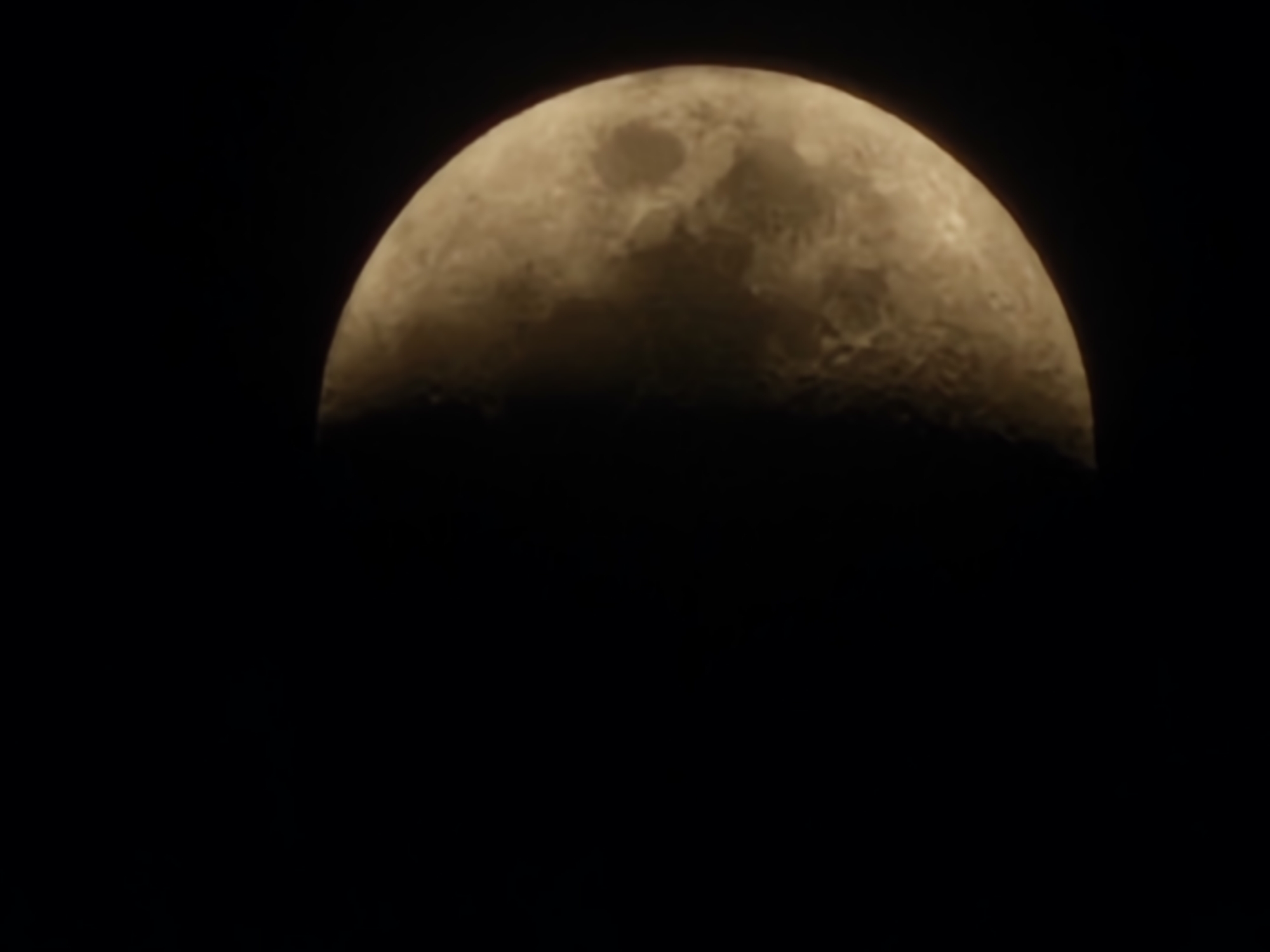 Waxing gibbous moon photographed over Esch-sur-Alzette at dusk