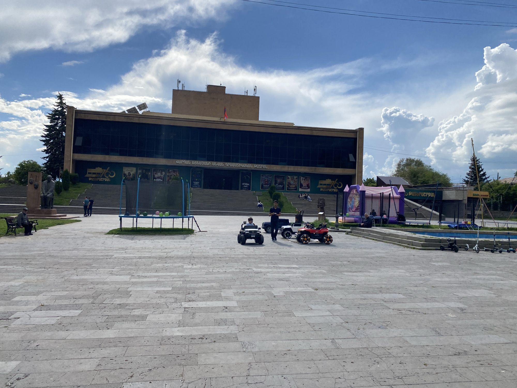 Witness documents Gyumri city center scenes, modern building and tiled sidewalk