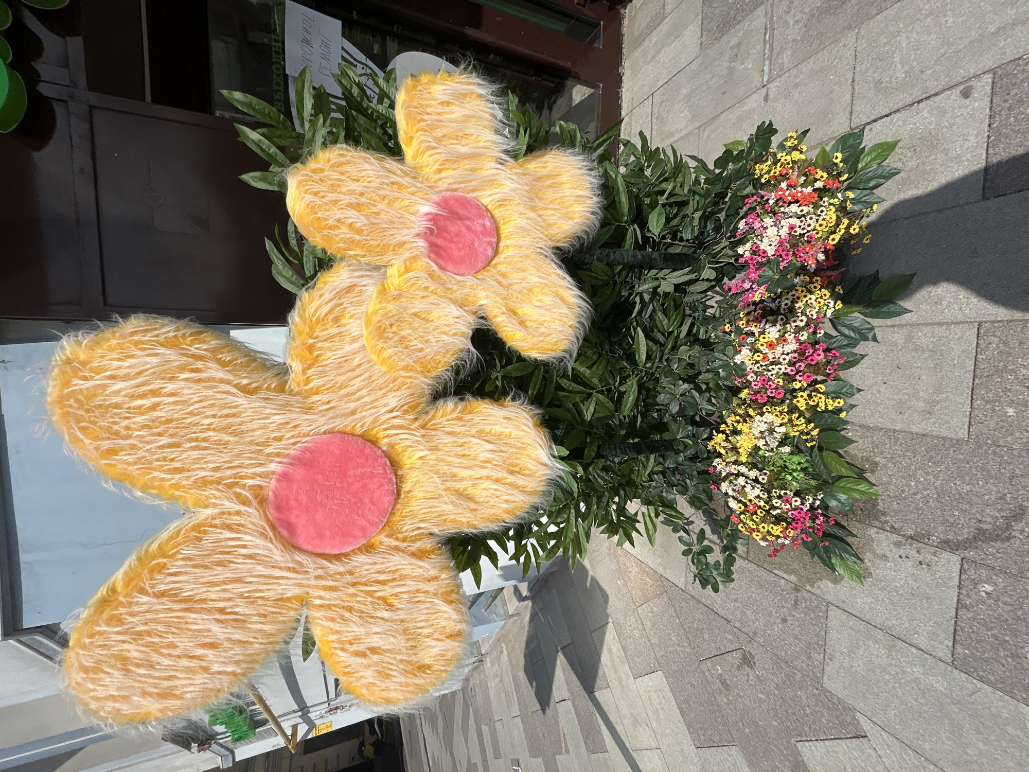 Large Yellow Fabric Flowers Spotted on City Street