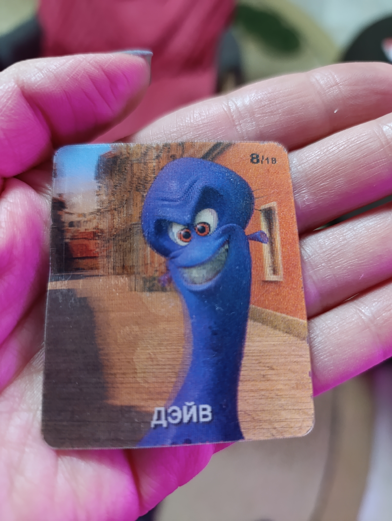 Person holds animated character card in Russian city