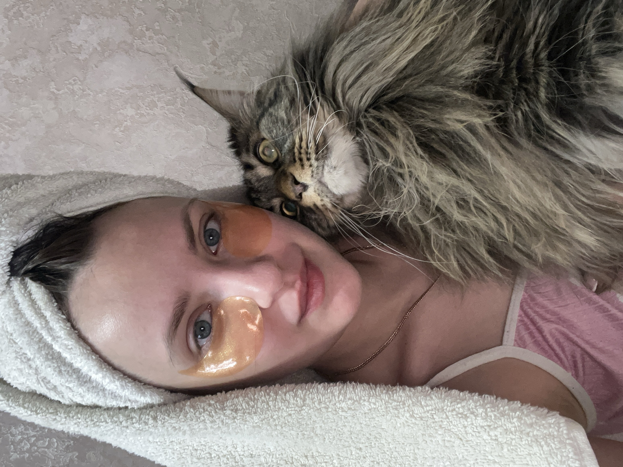 Woman rests with large cat in Марковский, Russia