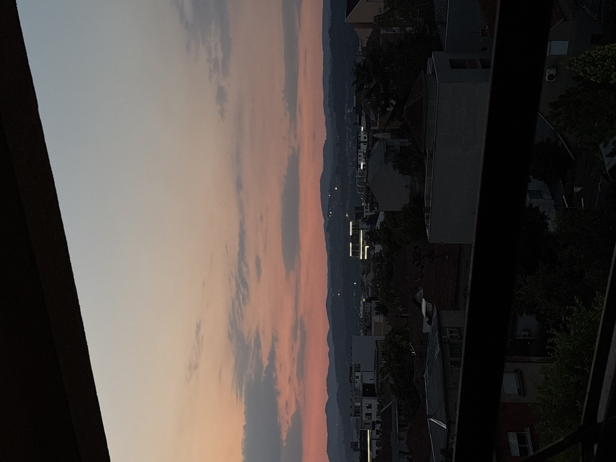 Kragujevac skyline at dusk, mountains silhouetted on the horizon