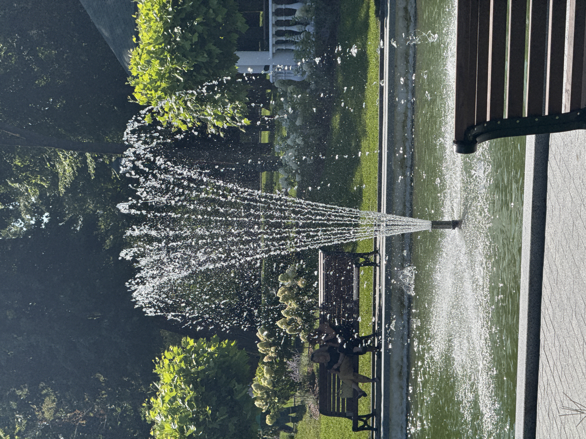 Sunny park morning: fountains, pond, and quiet walkways