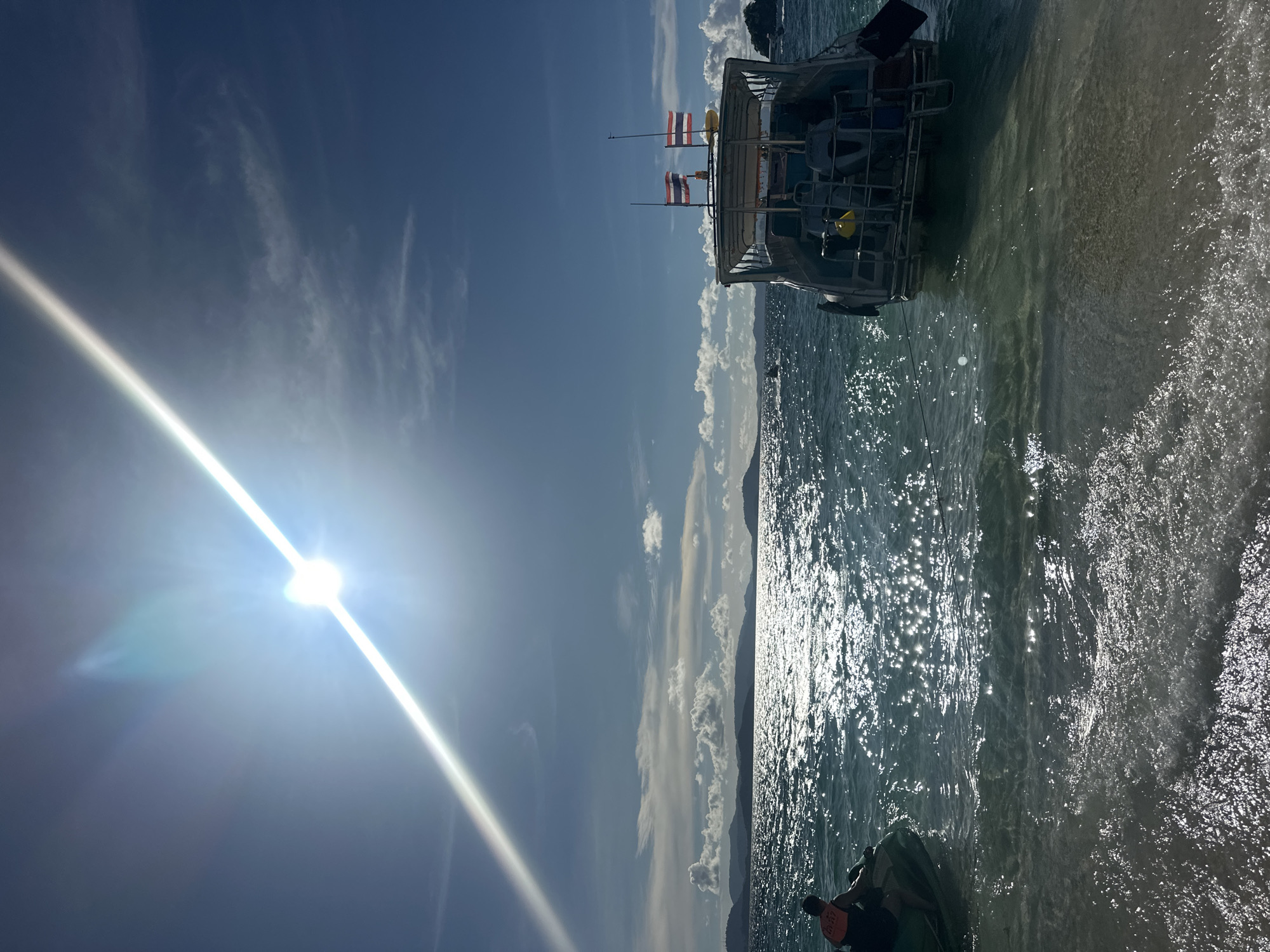 Bright morning at Phru Nai beach, people in the water