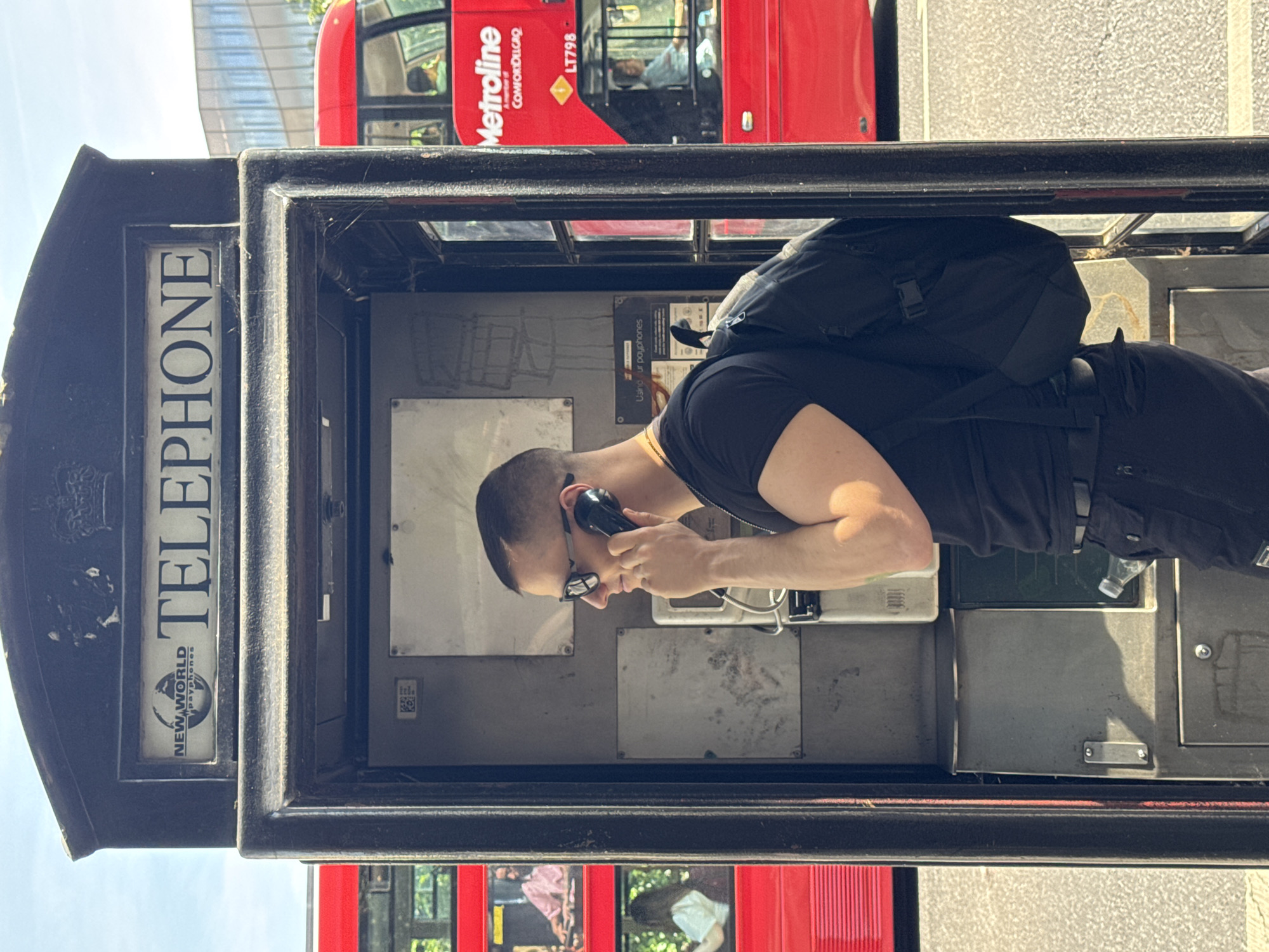 Man uses traditional phone booth near St. Paul's Cathedral