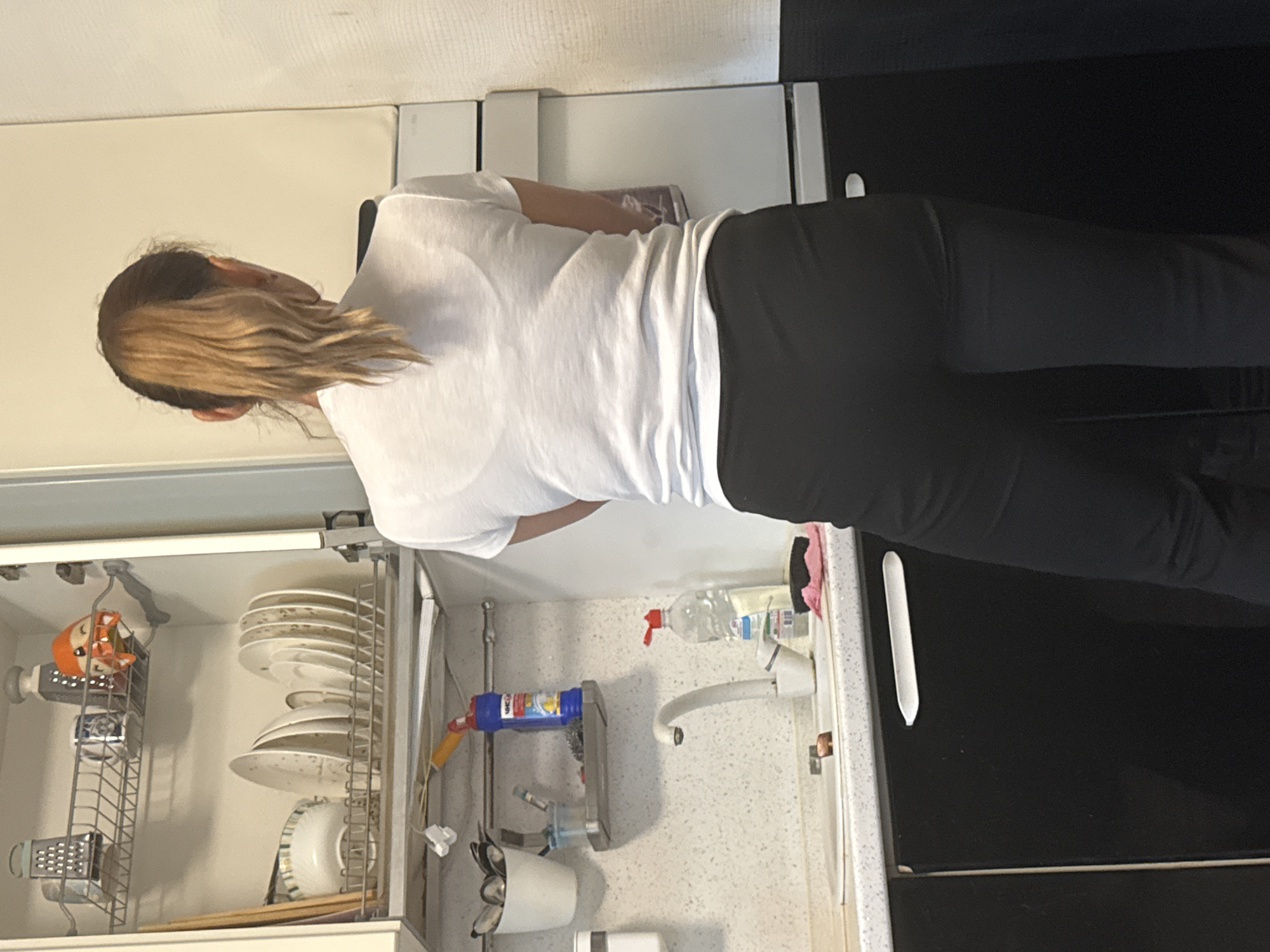 Woman observed doing kitchen tasks in Yekaterinburg home