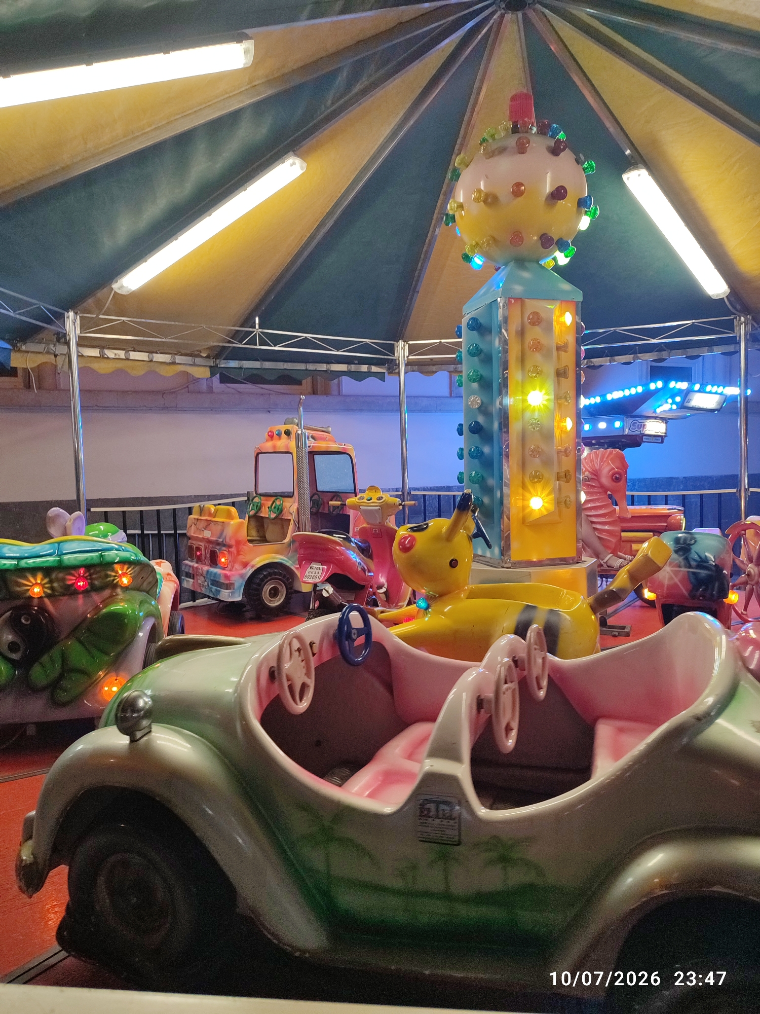 Summer night out in Militello: market stalls, carousel, and a rally