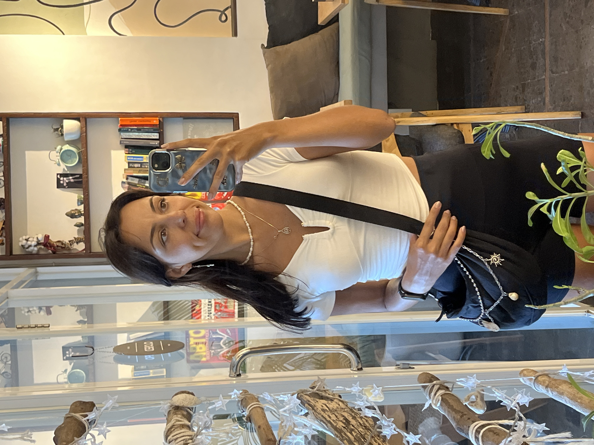 Woman takes selfies during morning shop visit in Kuta Selatan