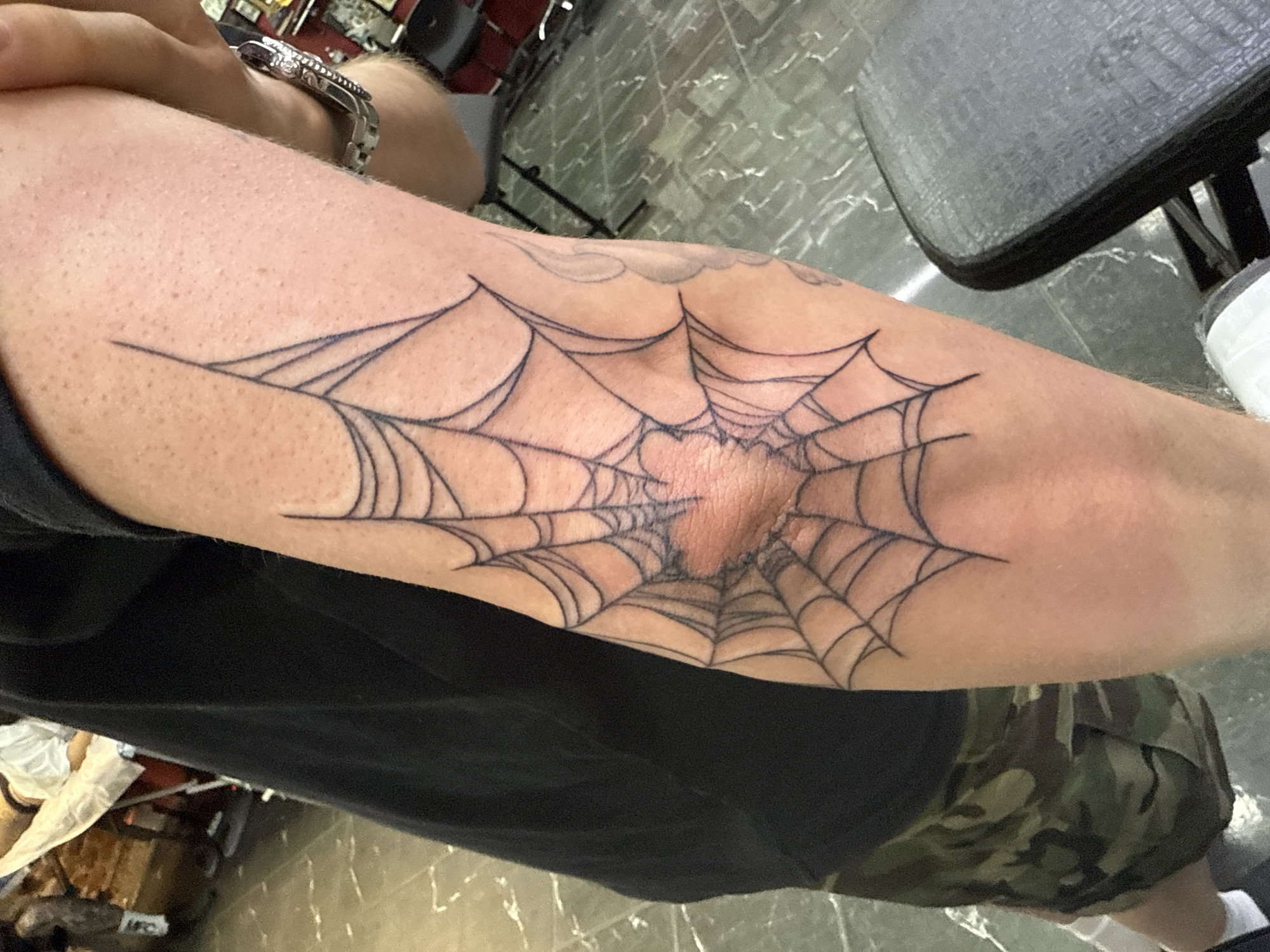Spiderweb elbow tattoo documented in Moscow