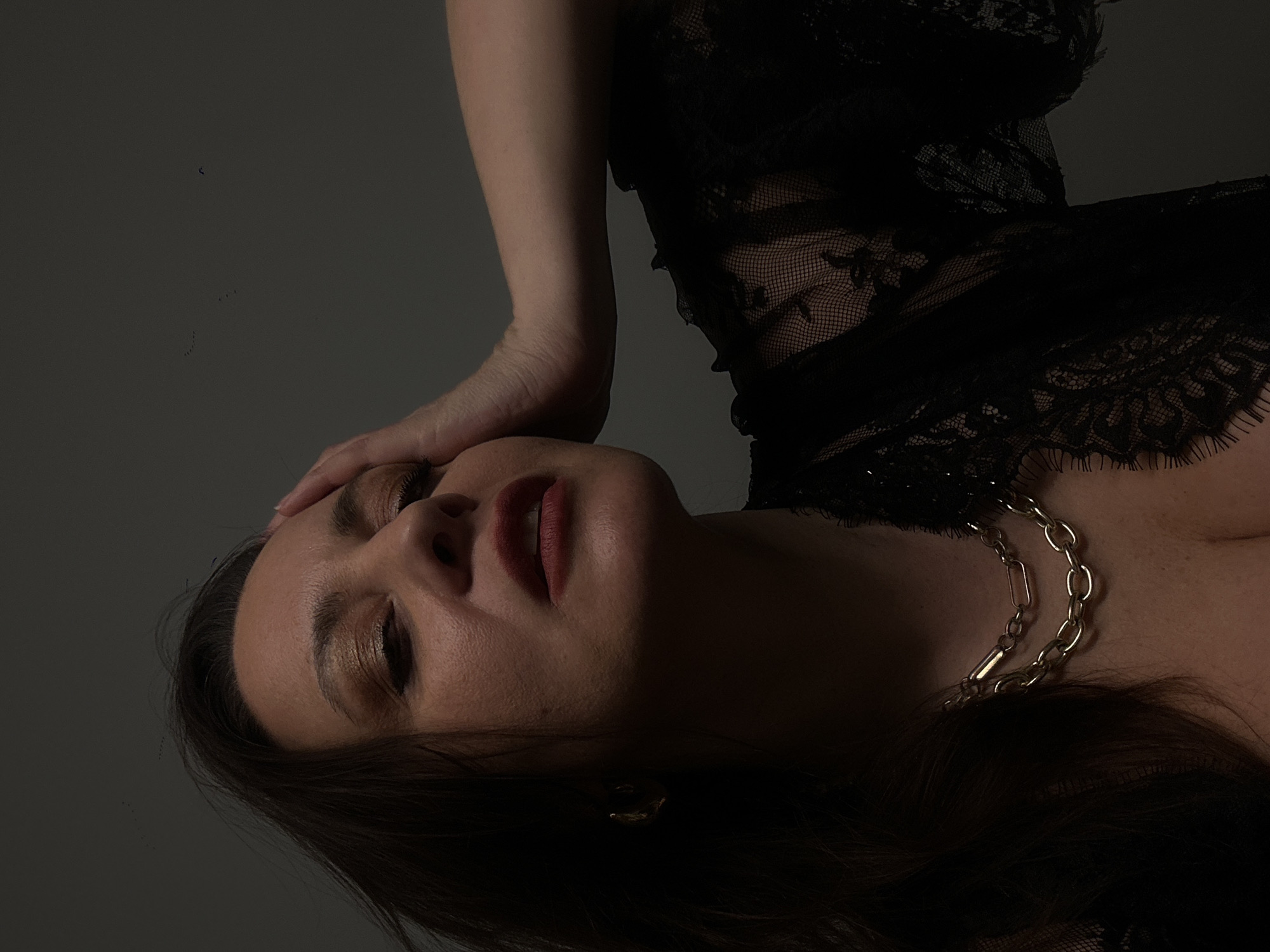 Portrait session captured in Riga featuring woman in black lace