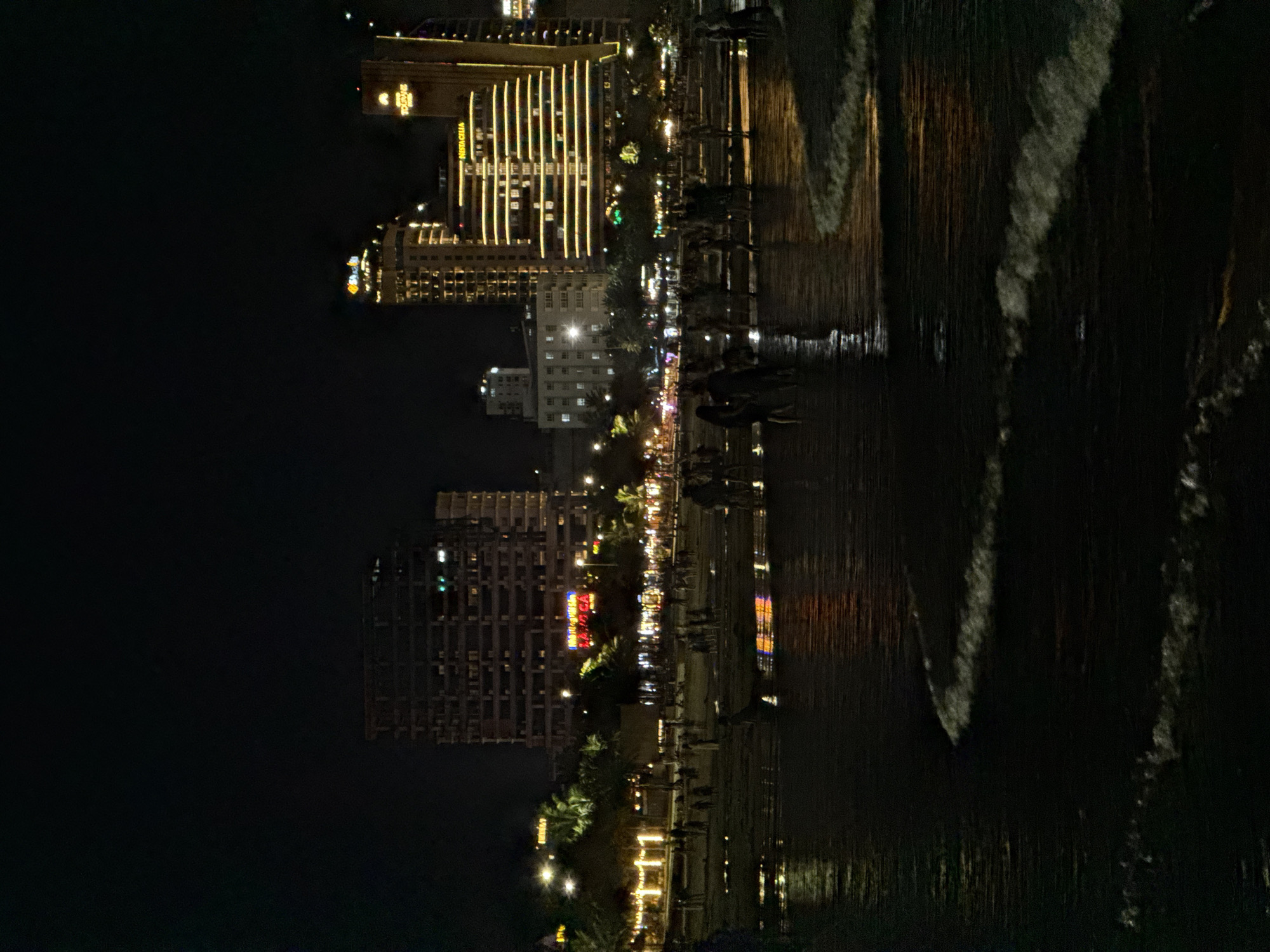 Da Nang beachfront at night, city lights and shoreline activity