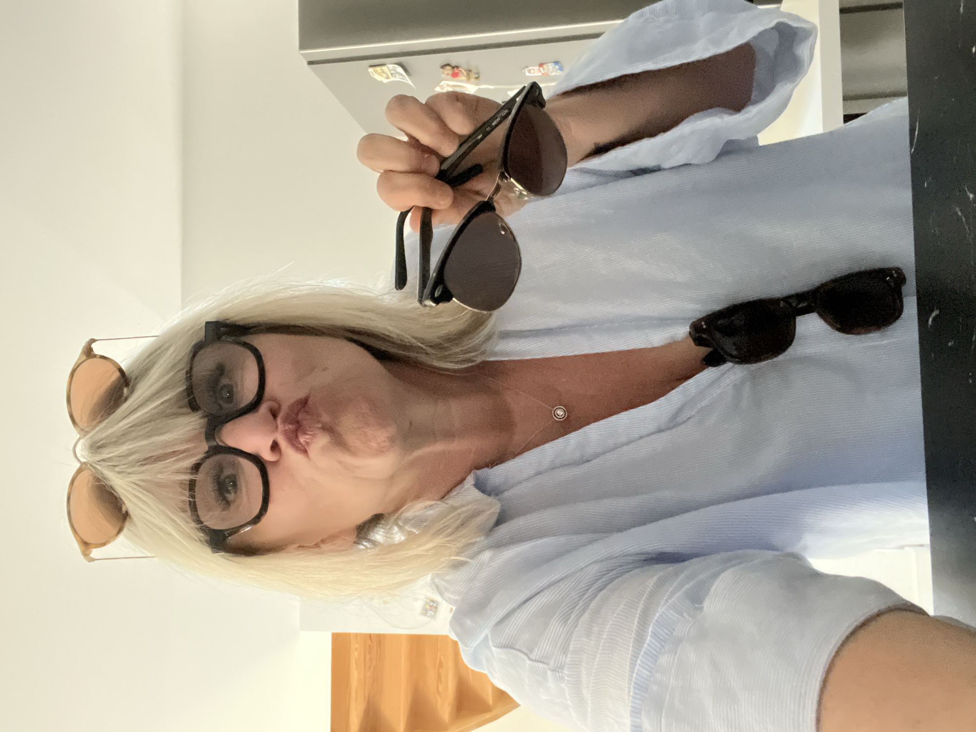 Woman packs suitcase, takes selfies while preparing for travel