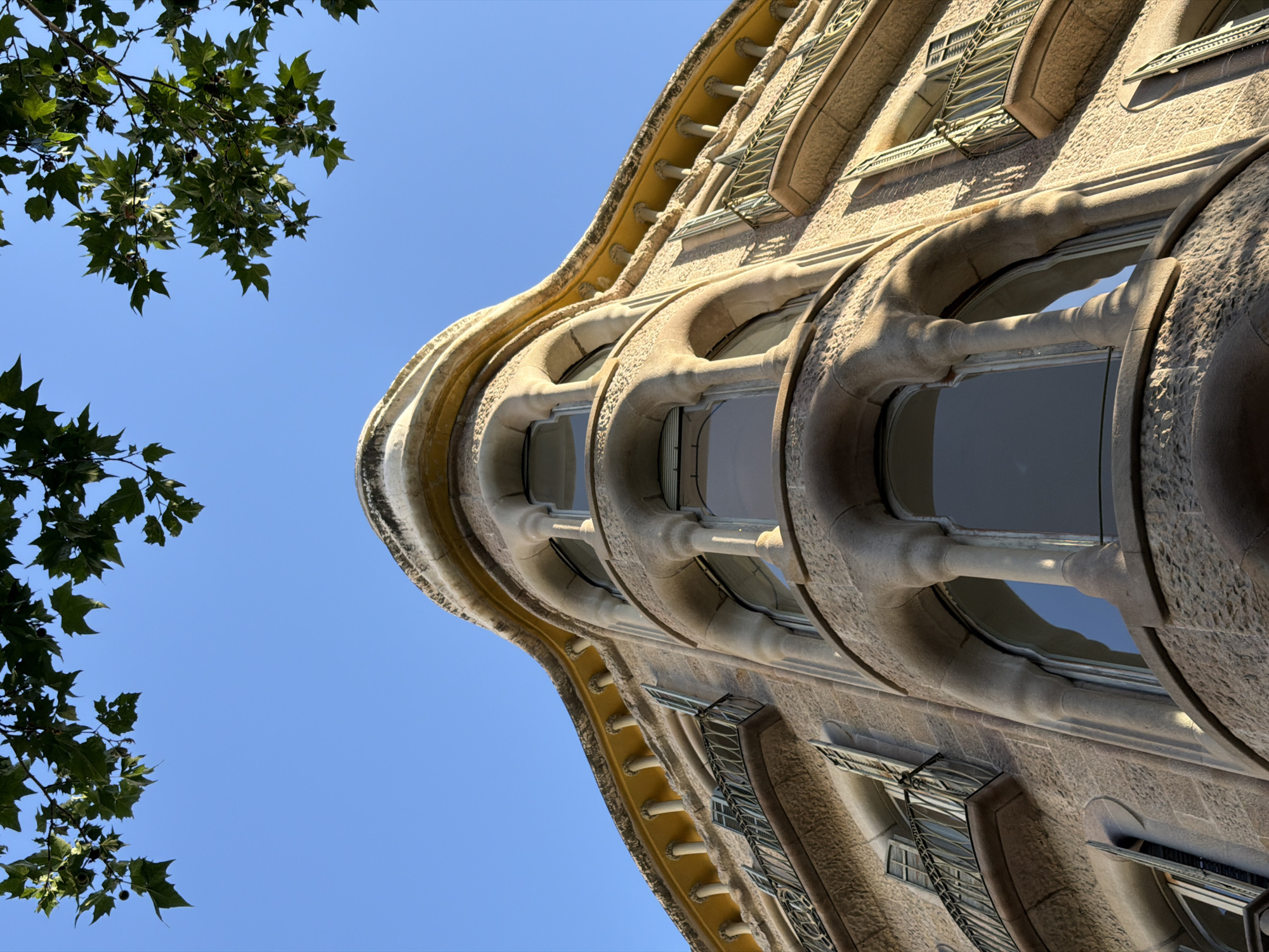 Tourist documents Gaudí architecture tour in Barcelona's Eixample district