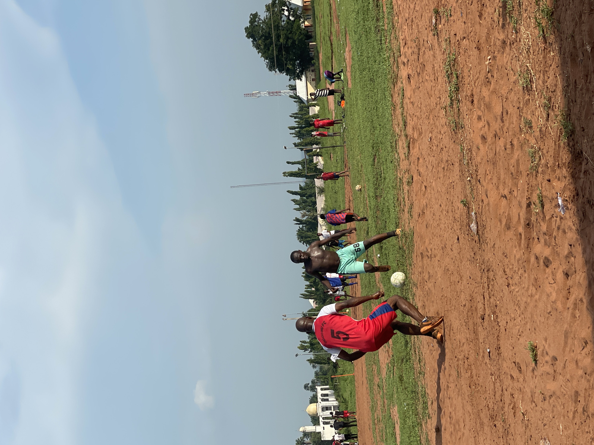 Afternoon soccer match played on dirt field in Ogbogbo