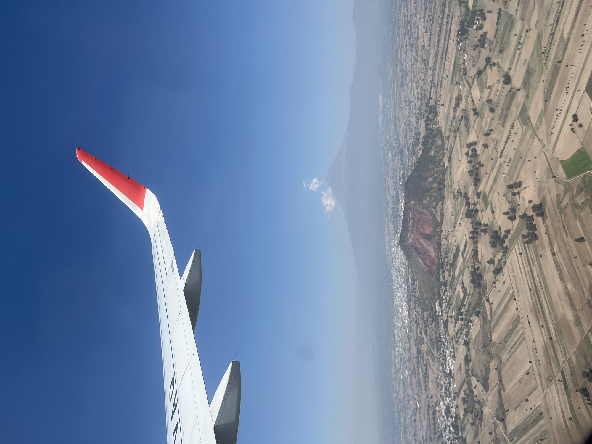 Aircraft flies over Santa María Zacatepec with clear skies