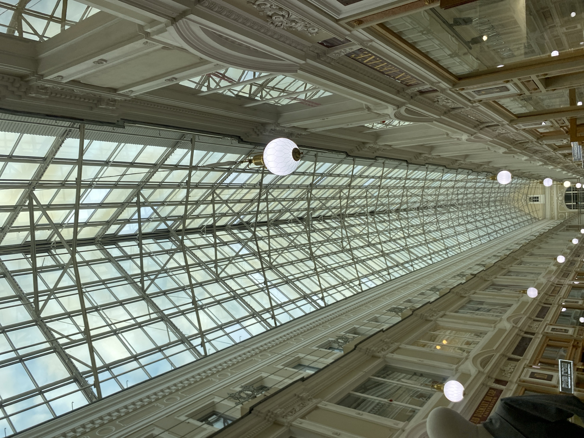 Tourists explore historic Passage shopping arcade in Saint Petersburg