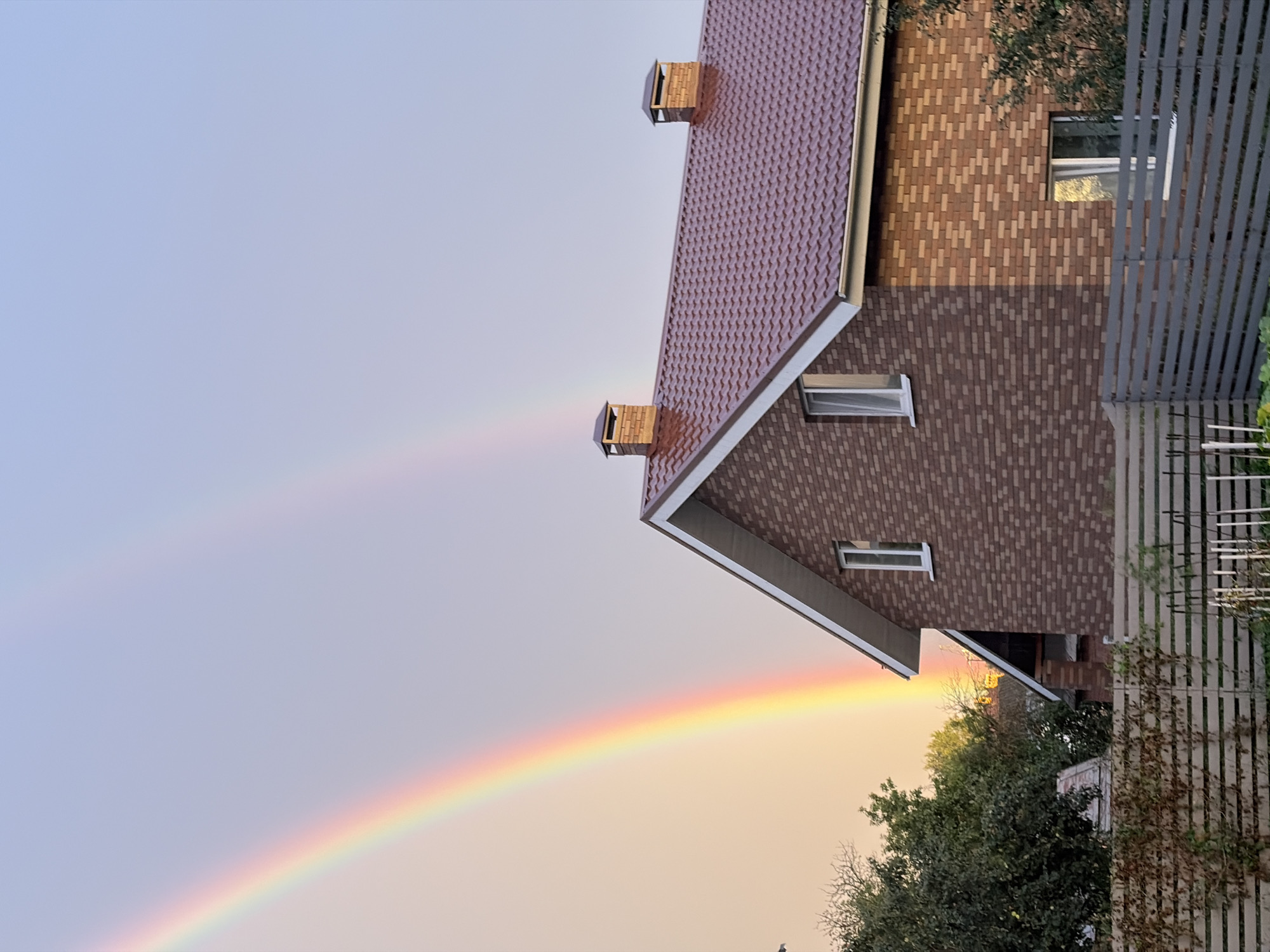 Double rainbow over a brick residential neighborhood