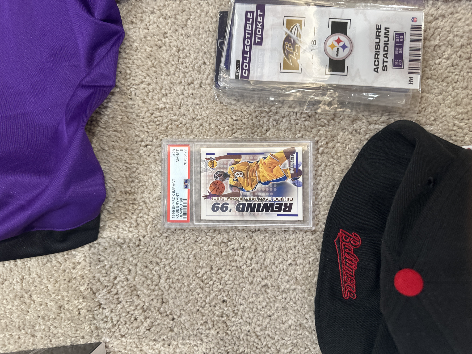 Sports memorabilia and personal items arranged on carpet in Aventura