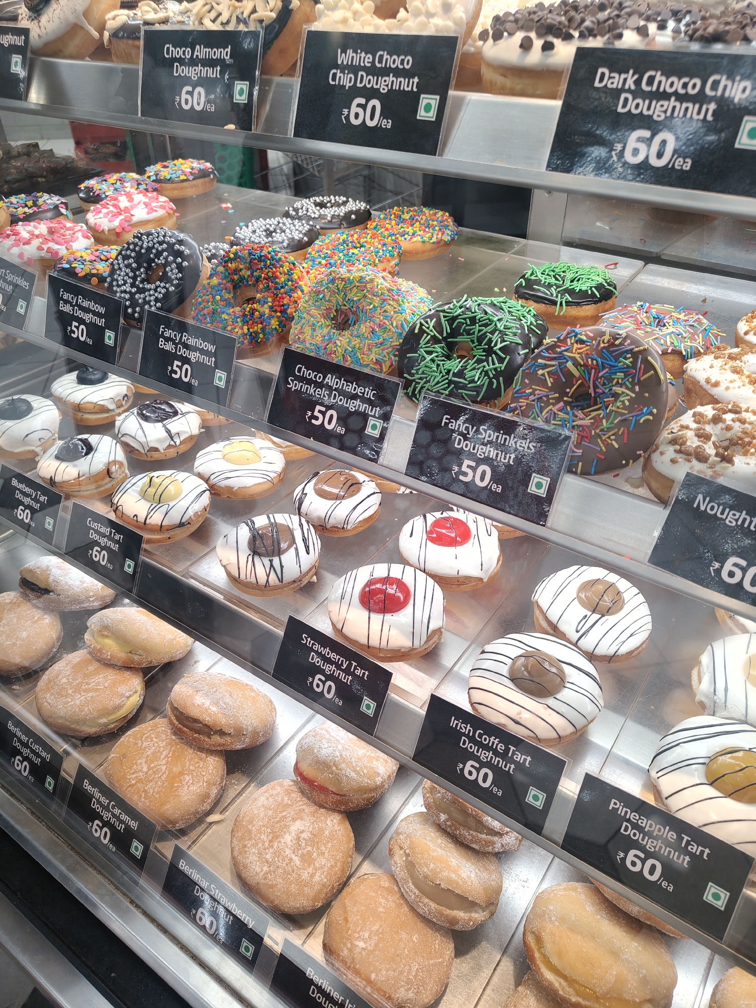 Customer surveys dessert displays at Bengaluru bakery during morning visit