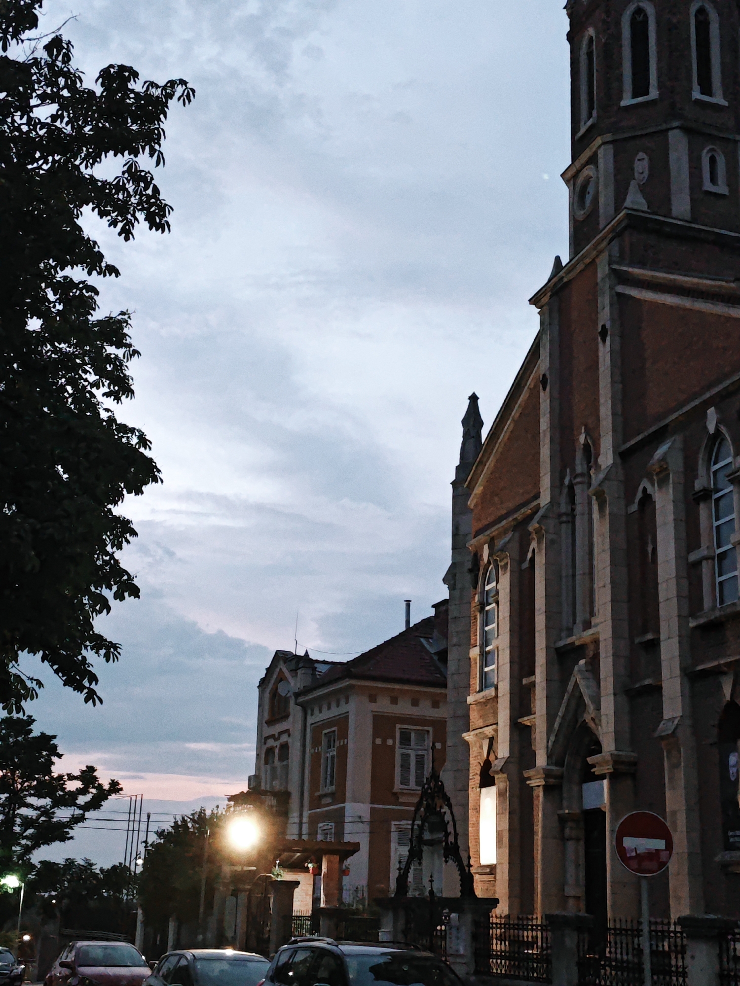 Dusk along a European riverfront city, golden hour to dark