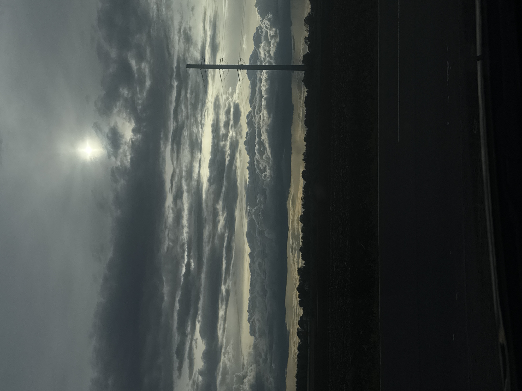 Overcast skies observed over rural area with utility infrastructure