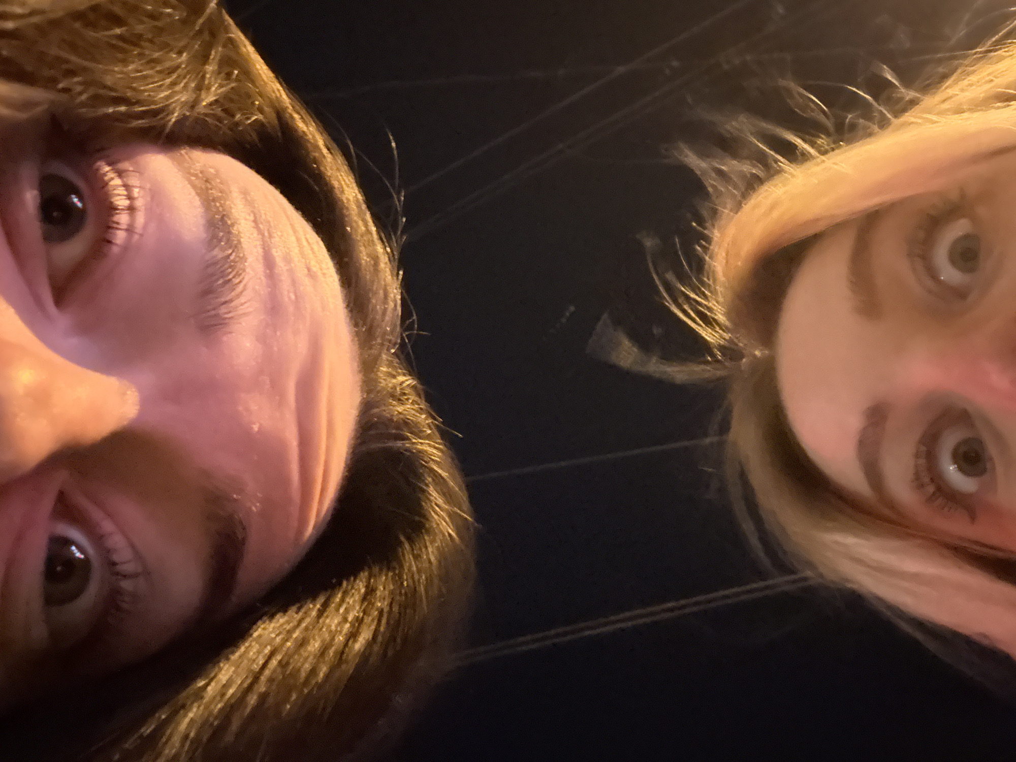 Women take selfies on sidewalk in Krasnoyarsk