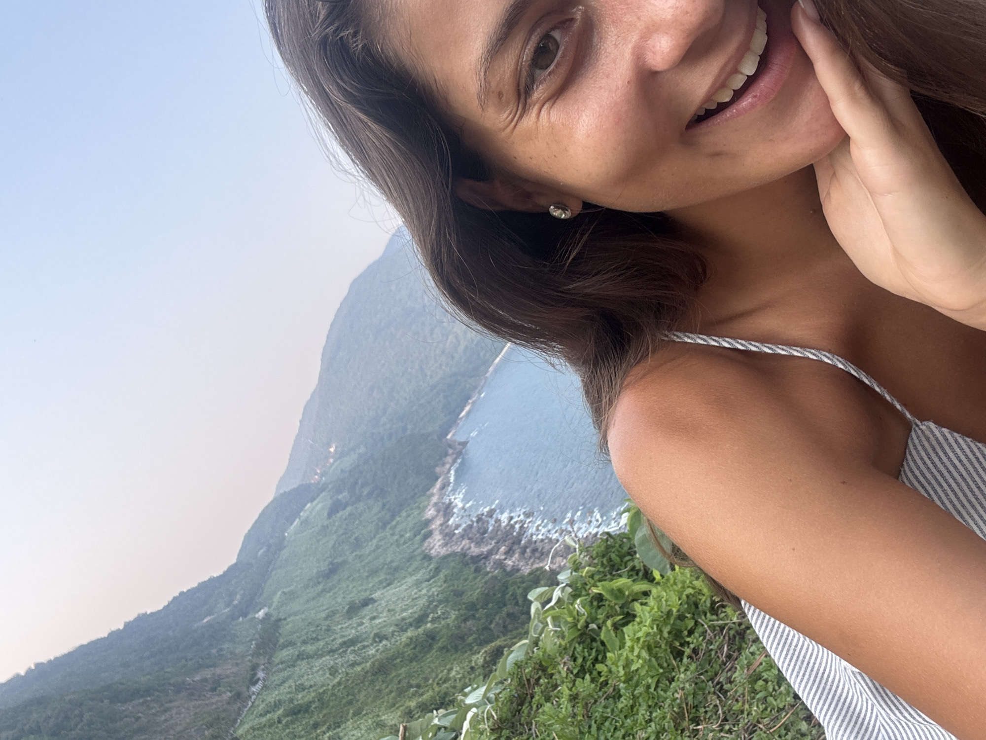 Woman photographs coastal mountain scenery in Đà Nẵng Vietnam