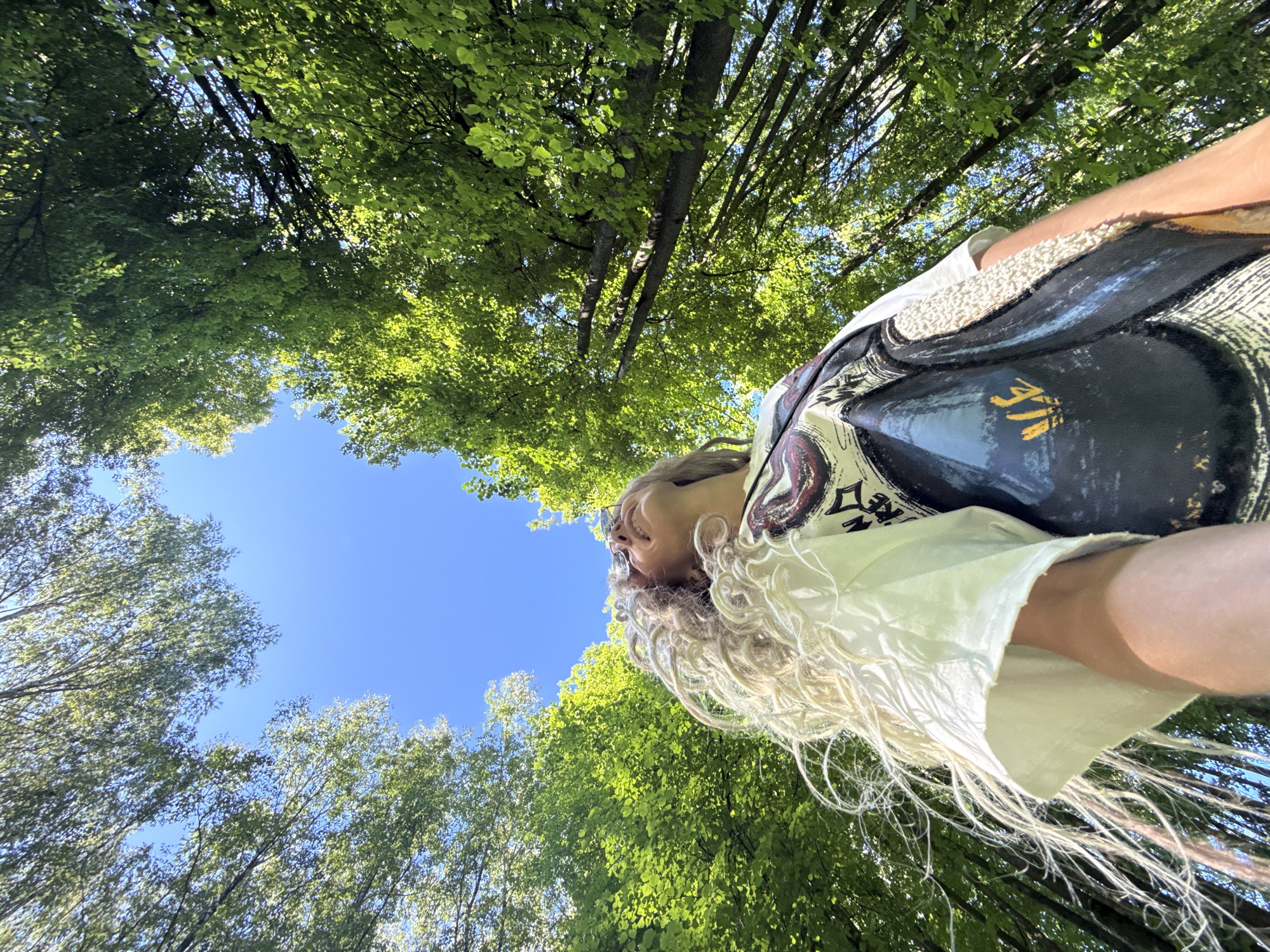 Woman photographed outdoors in sunny Rusanovo park setting