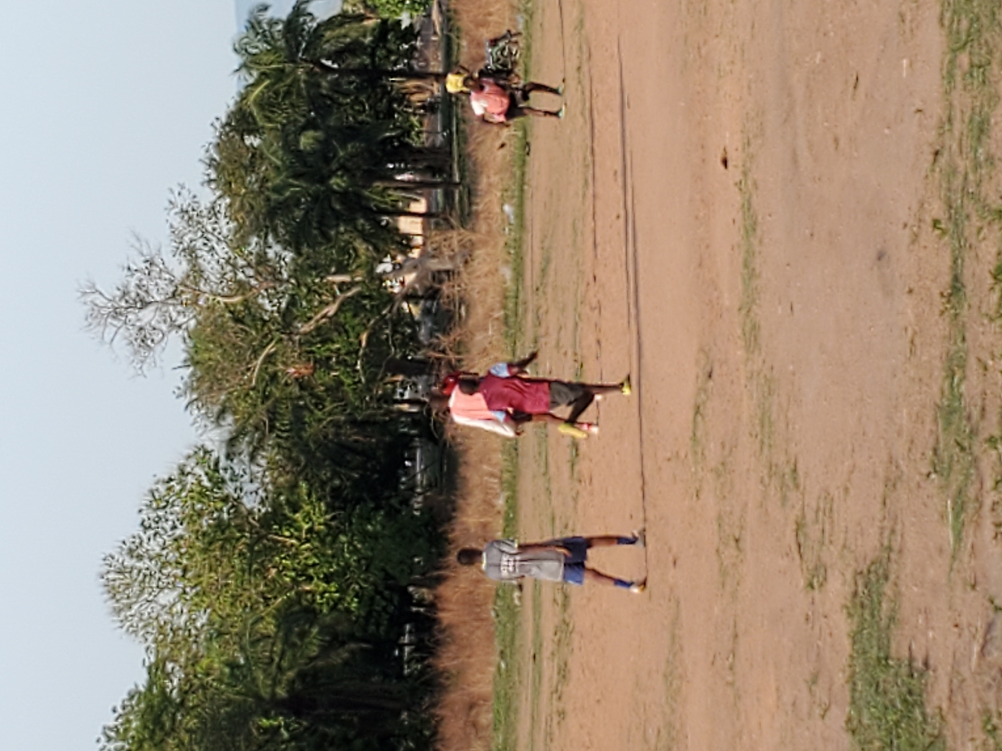Soccer game played on dirt field in Mararaba