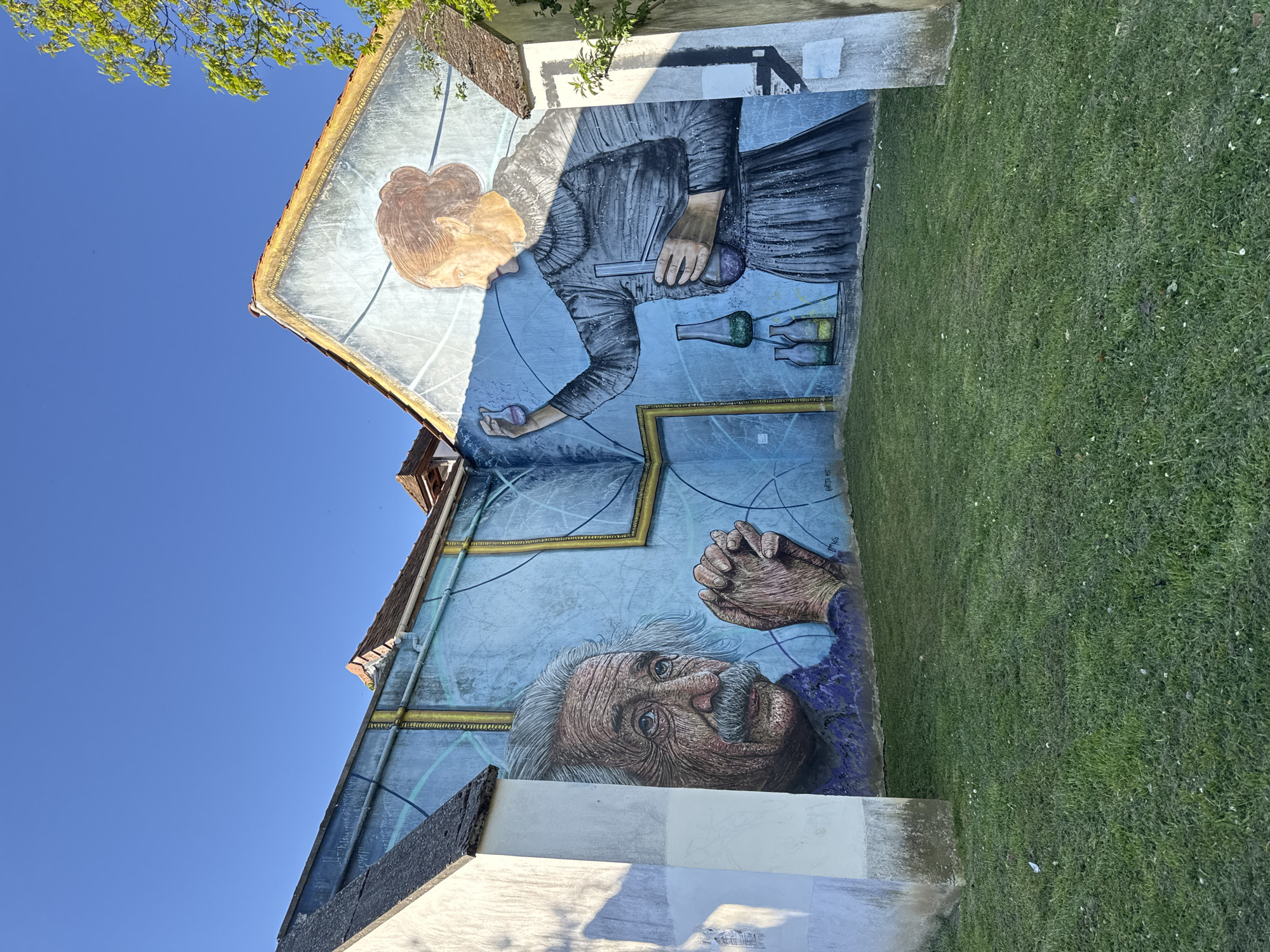 Person photographed near Curie-Einstein mural in Palaiseau, France