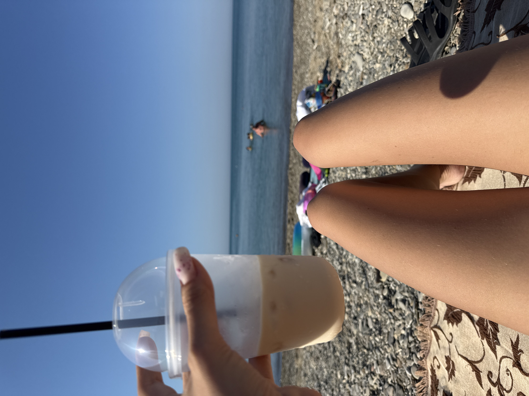 Relaxing on a pebble beach in Dzhubga with a drink