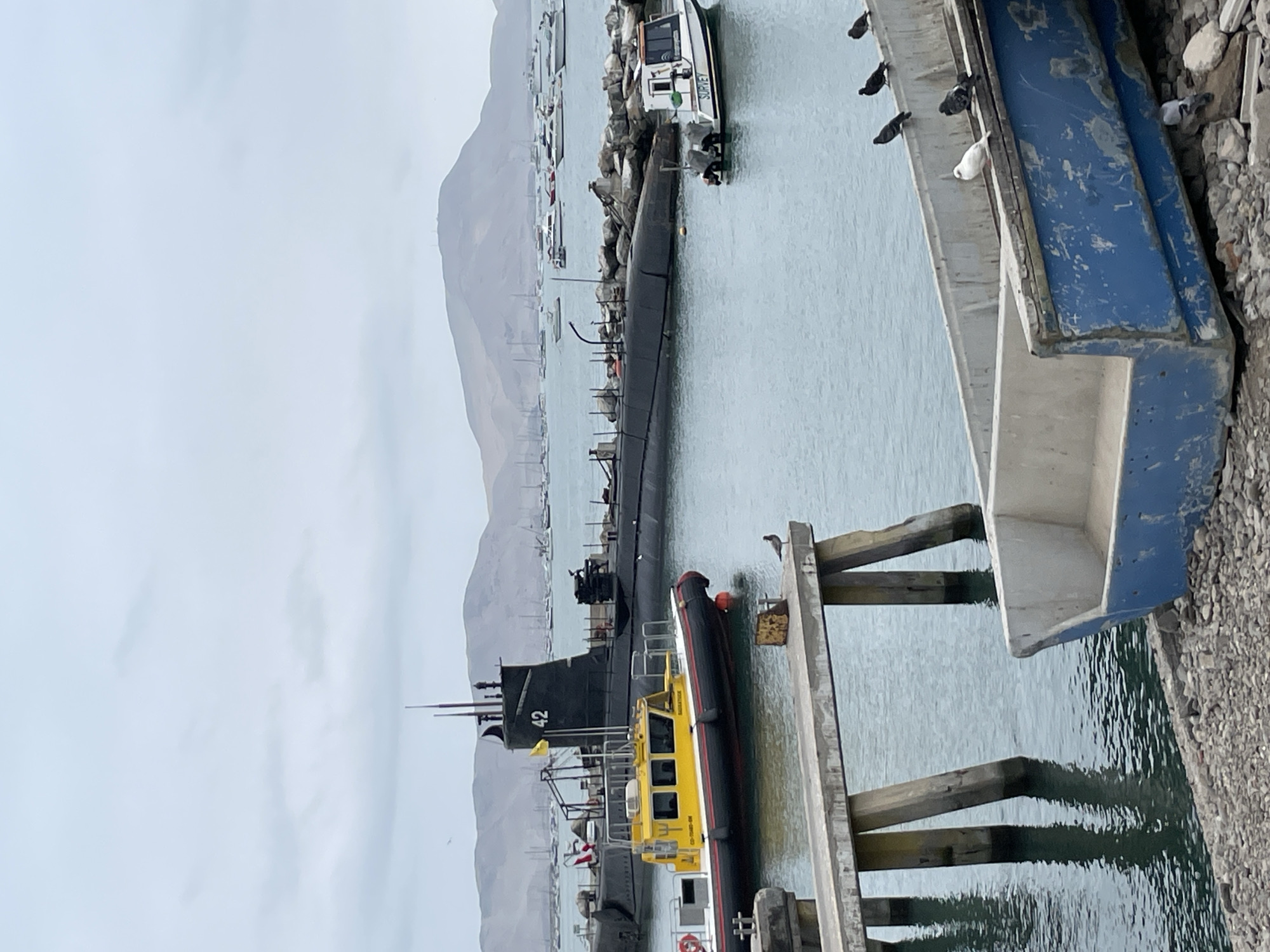 Callao harbor: fishing boats, a navy submarine, and shoreline life