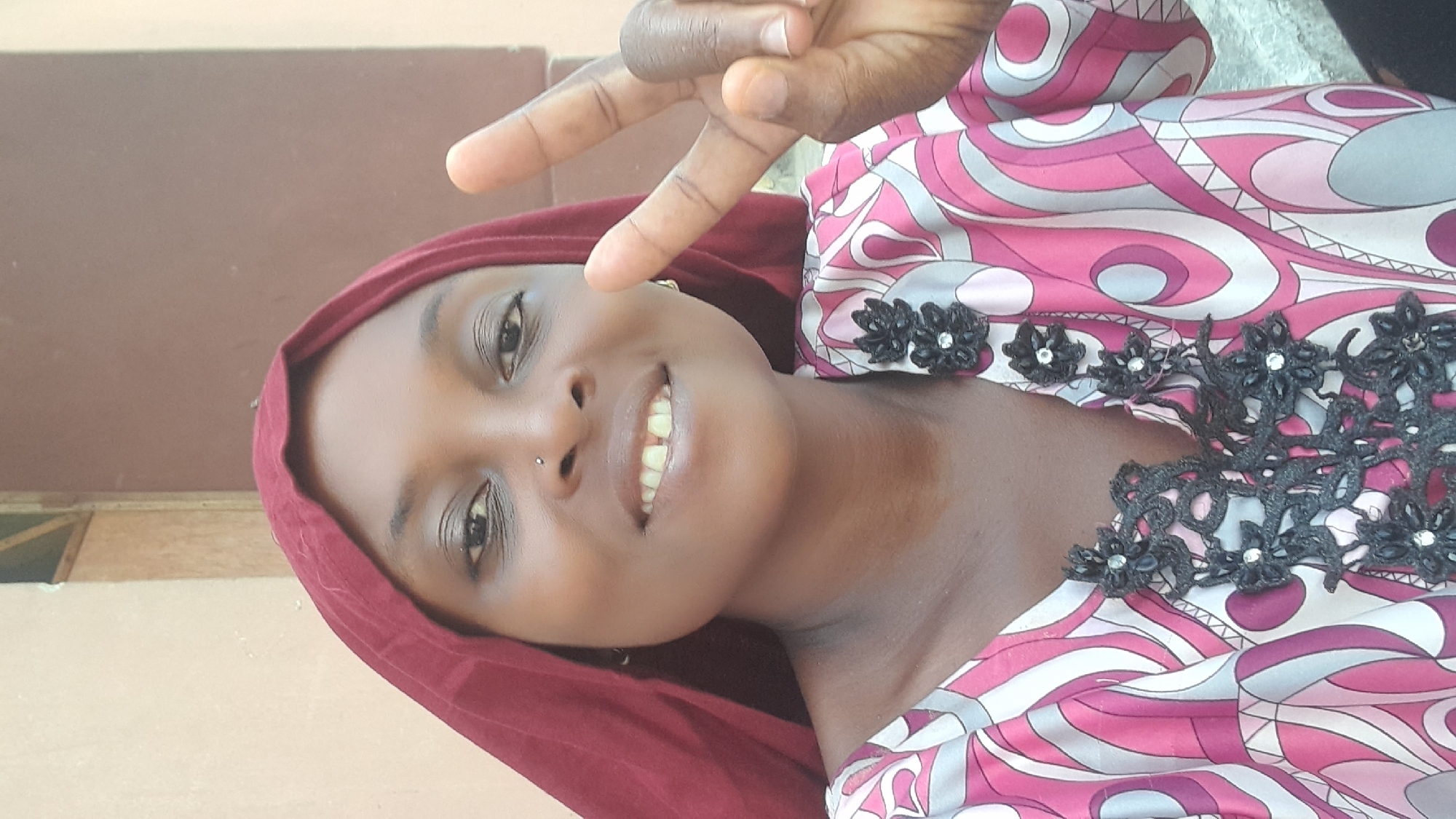 Woman does laundry, poses for photos in Ado courtyard