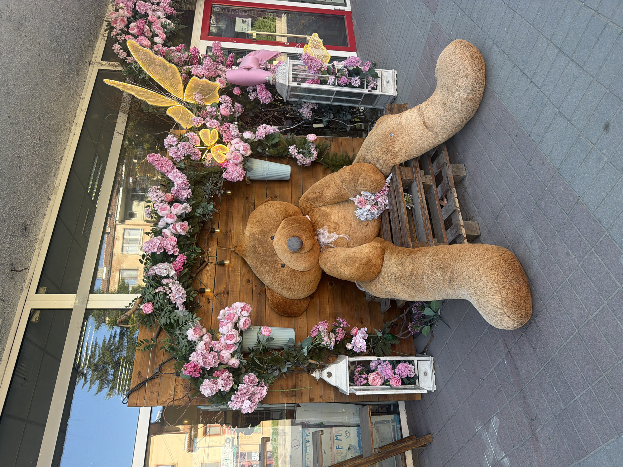Elaborate teddy bear display decorates Lukovit storefront with flowers