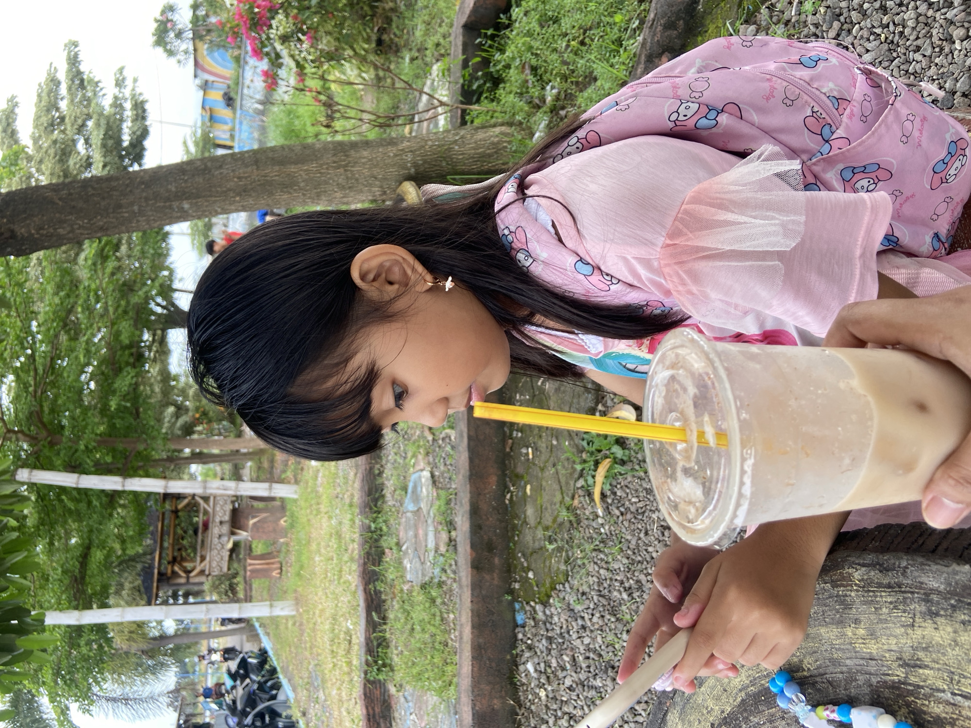 Girl enjoys morning outing at Indonesian waterfront park