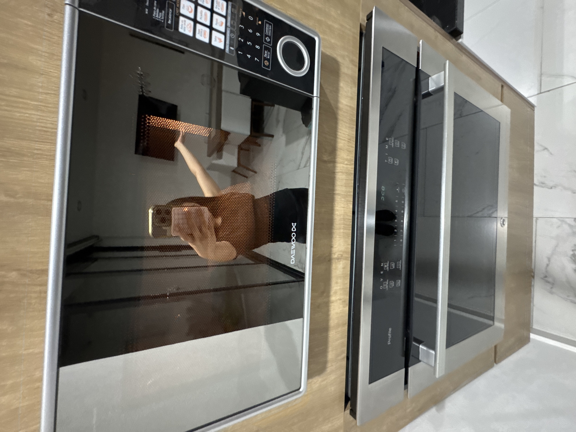 Person documents kitchen appliances in Puebla home