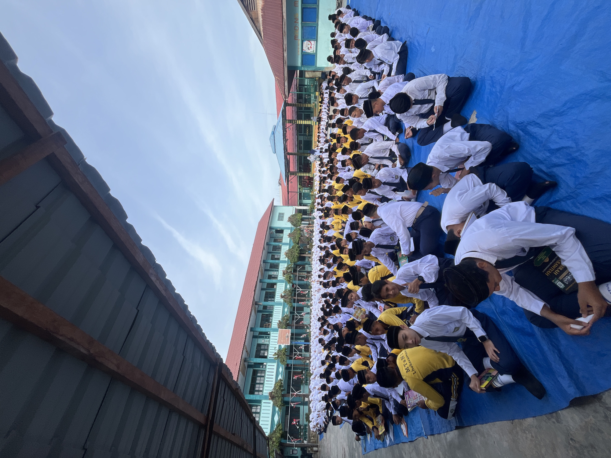 Outdoor school assembly underway at Lhokseumawe campus