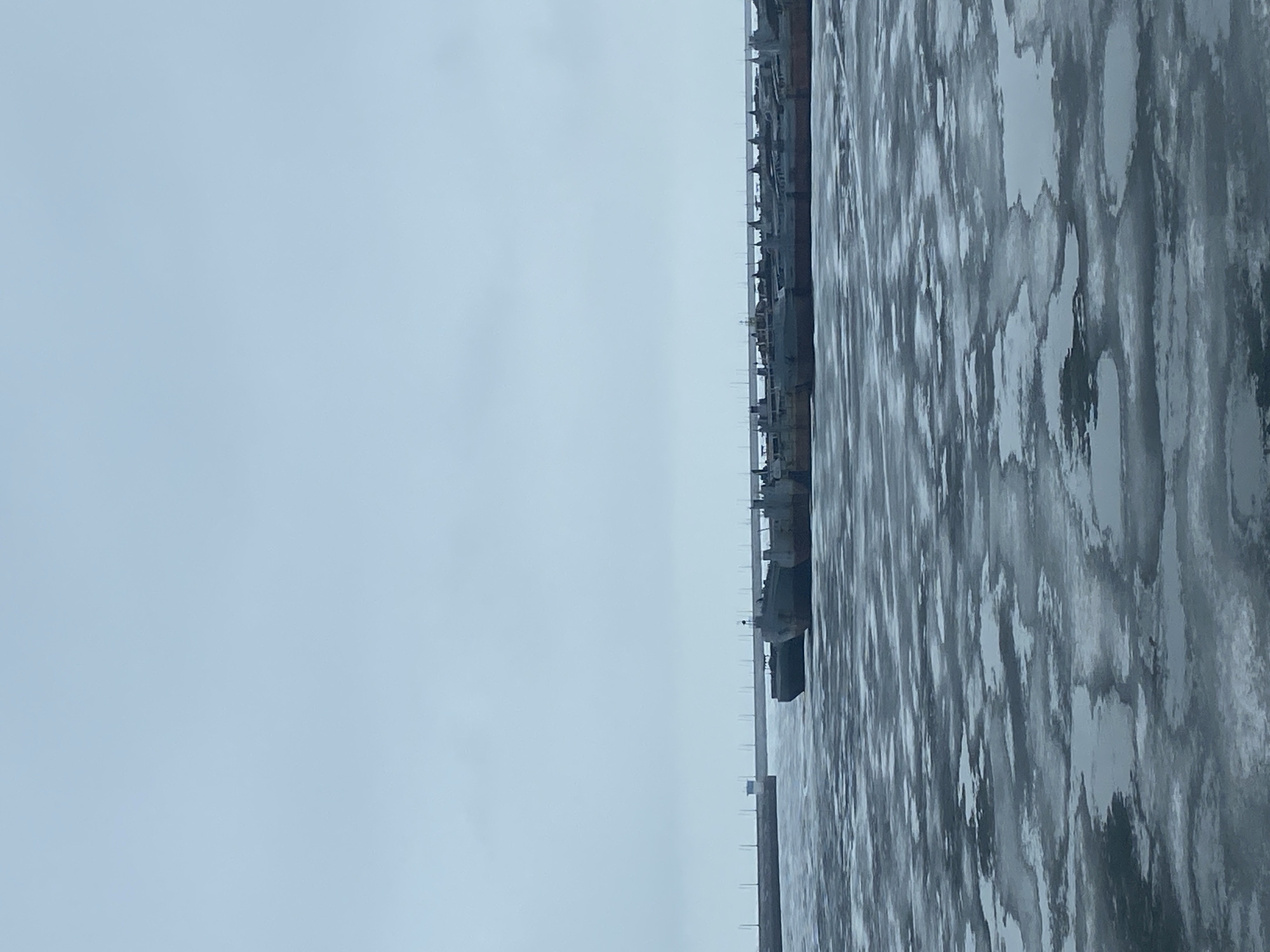 Ships docked at frozen pier in Chaikovsky, Russia