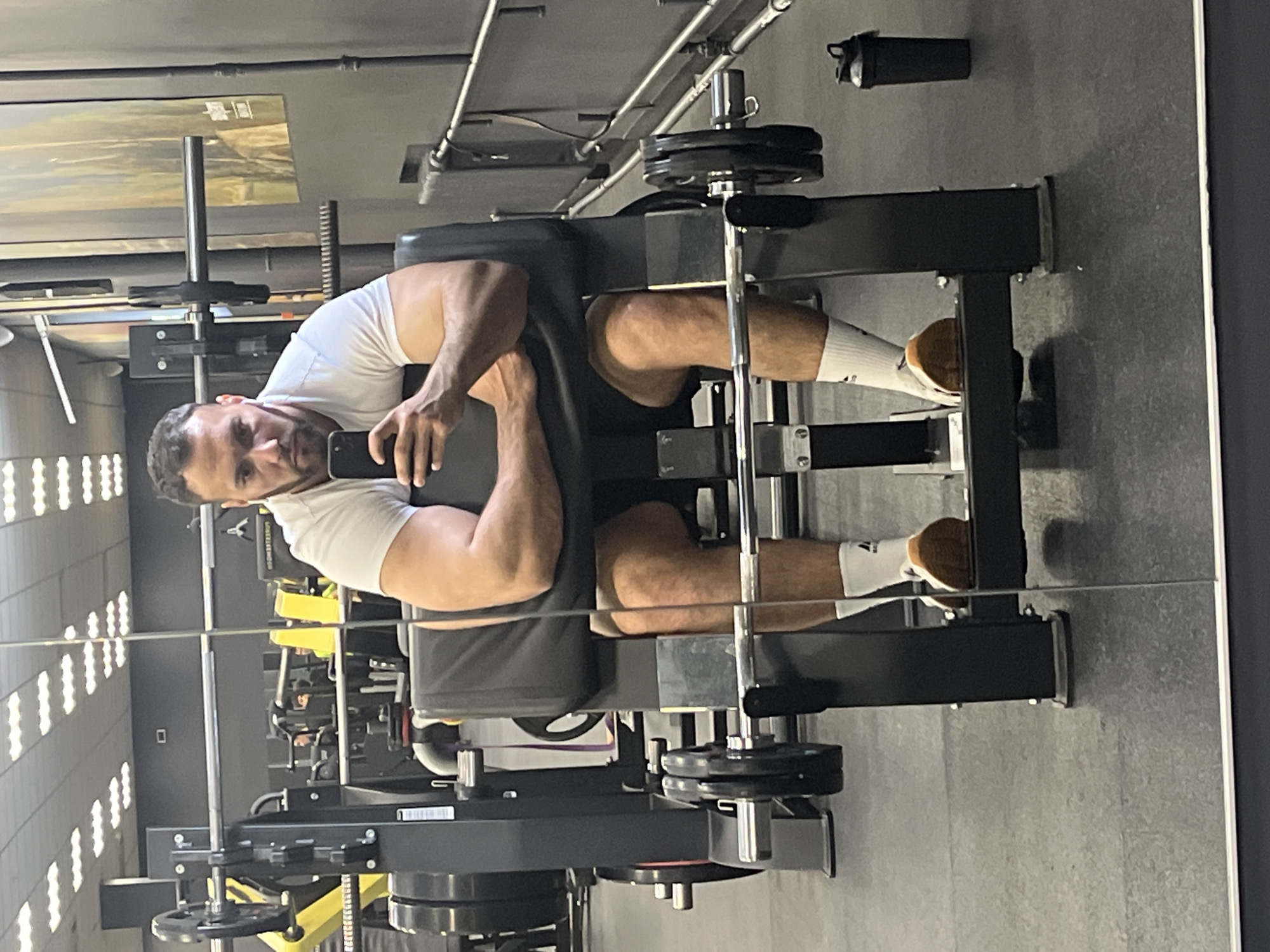 Man uses phone while exercising at Ulyanovsk gym