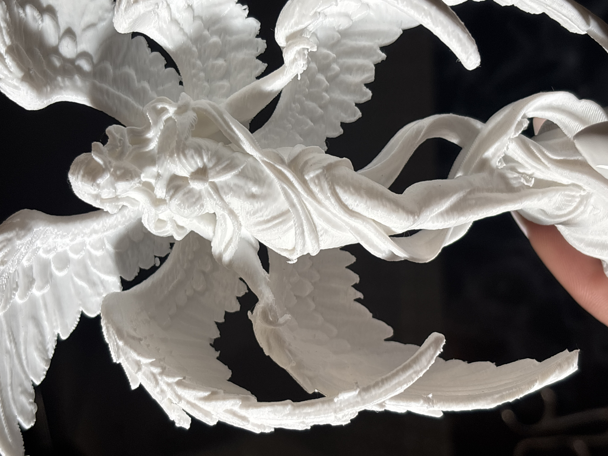 Person examines 3D-printed angel figurine in Sofia