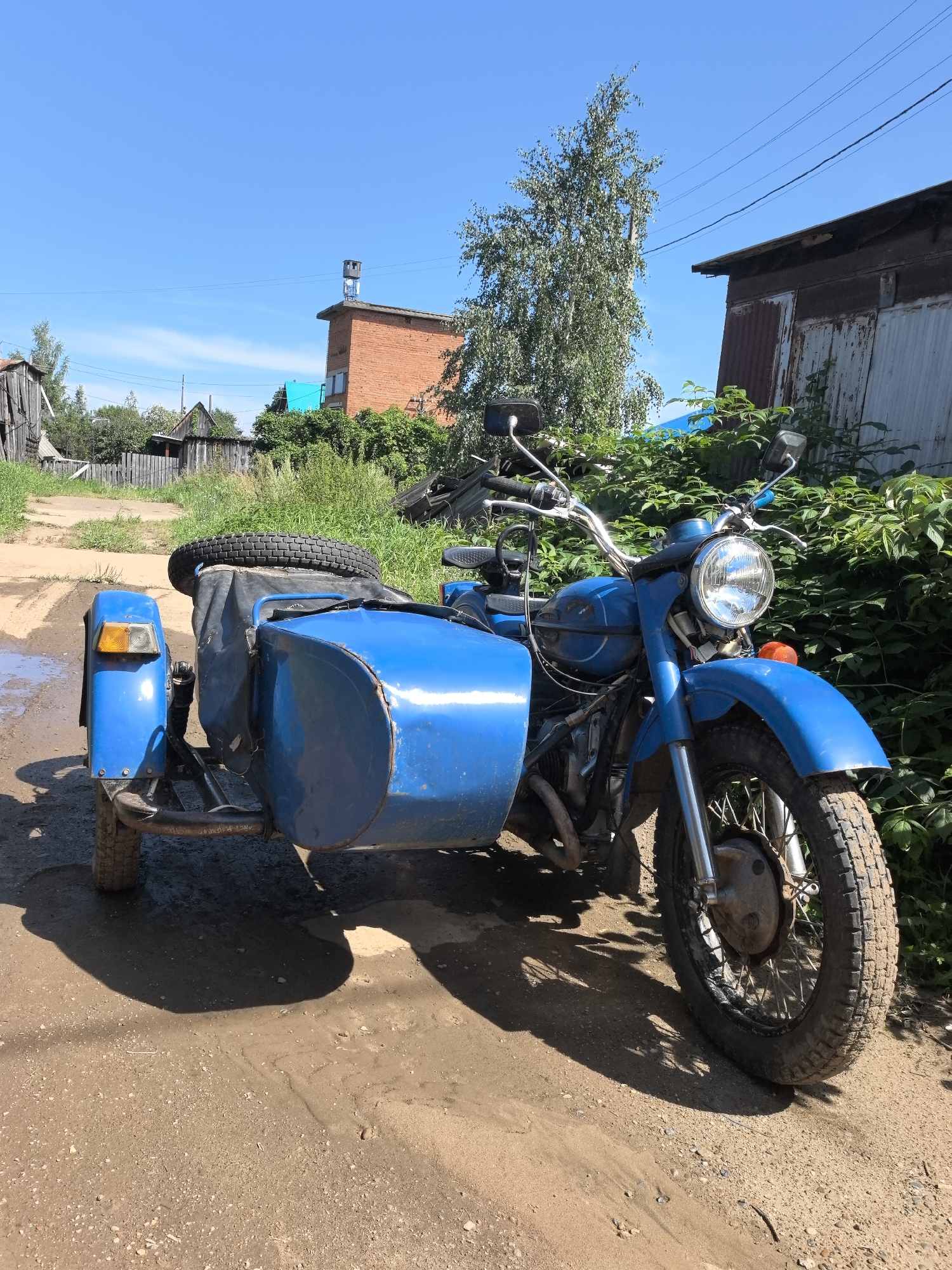 Vintage motorcycles and Orthodox domes in rural Noviy, Russia
