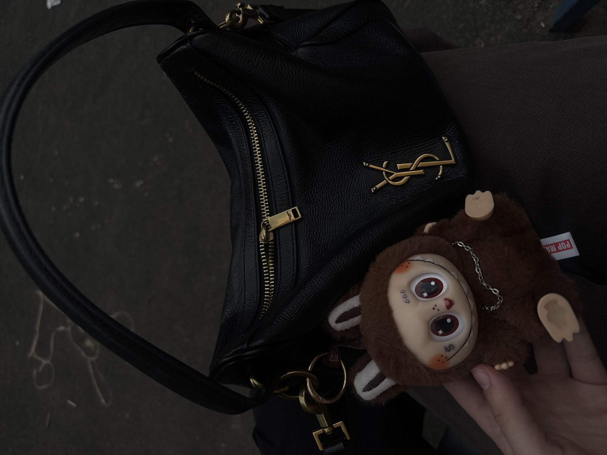 YSL handbag photographed on lap in Lyubertsy, Russia
