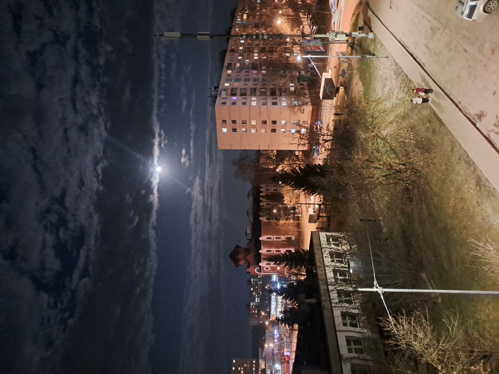 Full moon illuminates Elektrostal apartment buildings on cloudy night