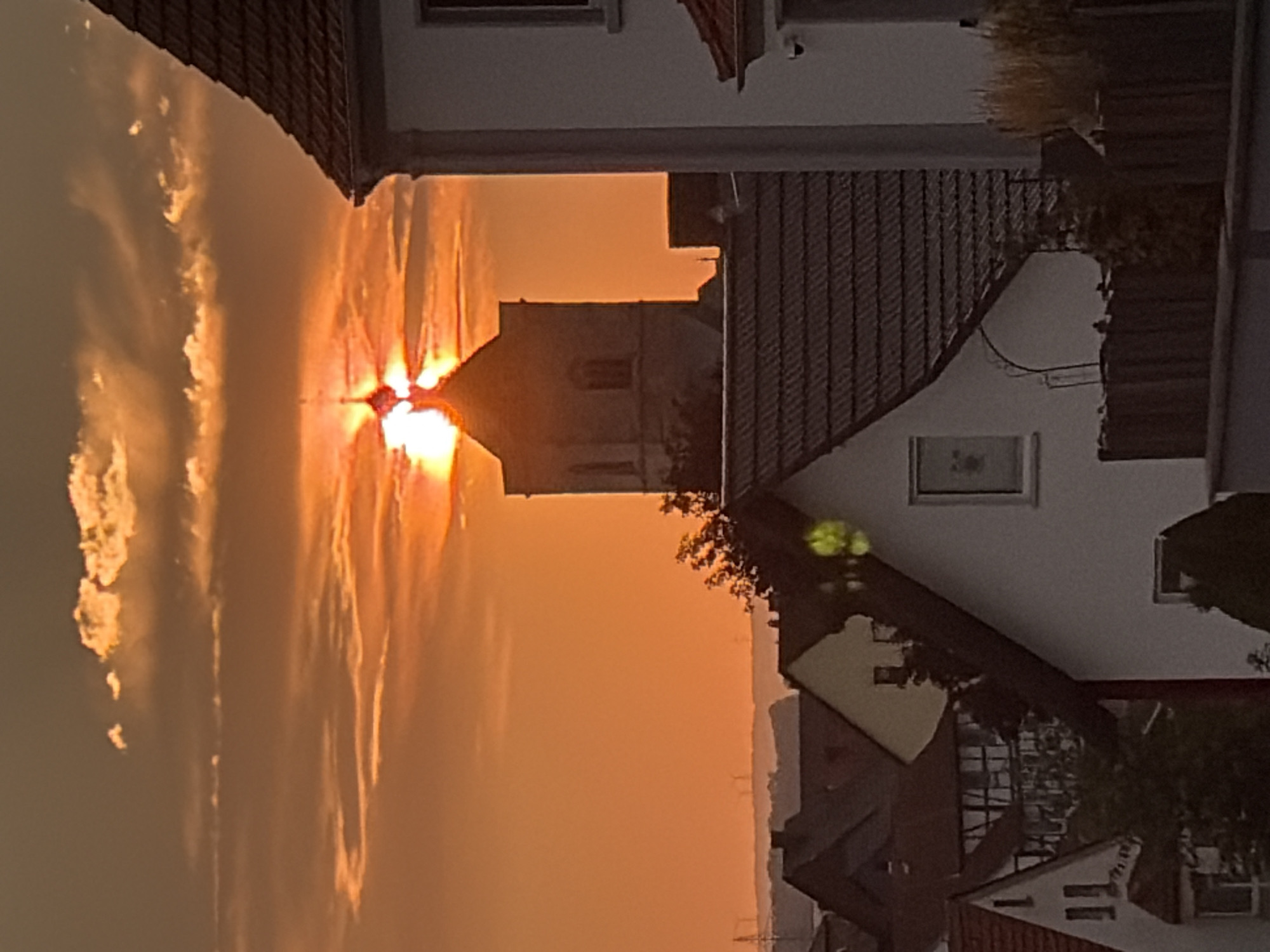 Urban sunset caught from two angles, warm sky over rooftops
