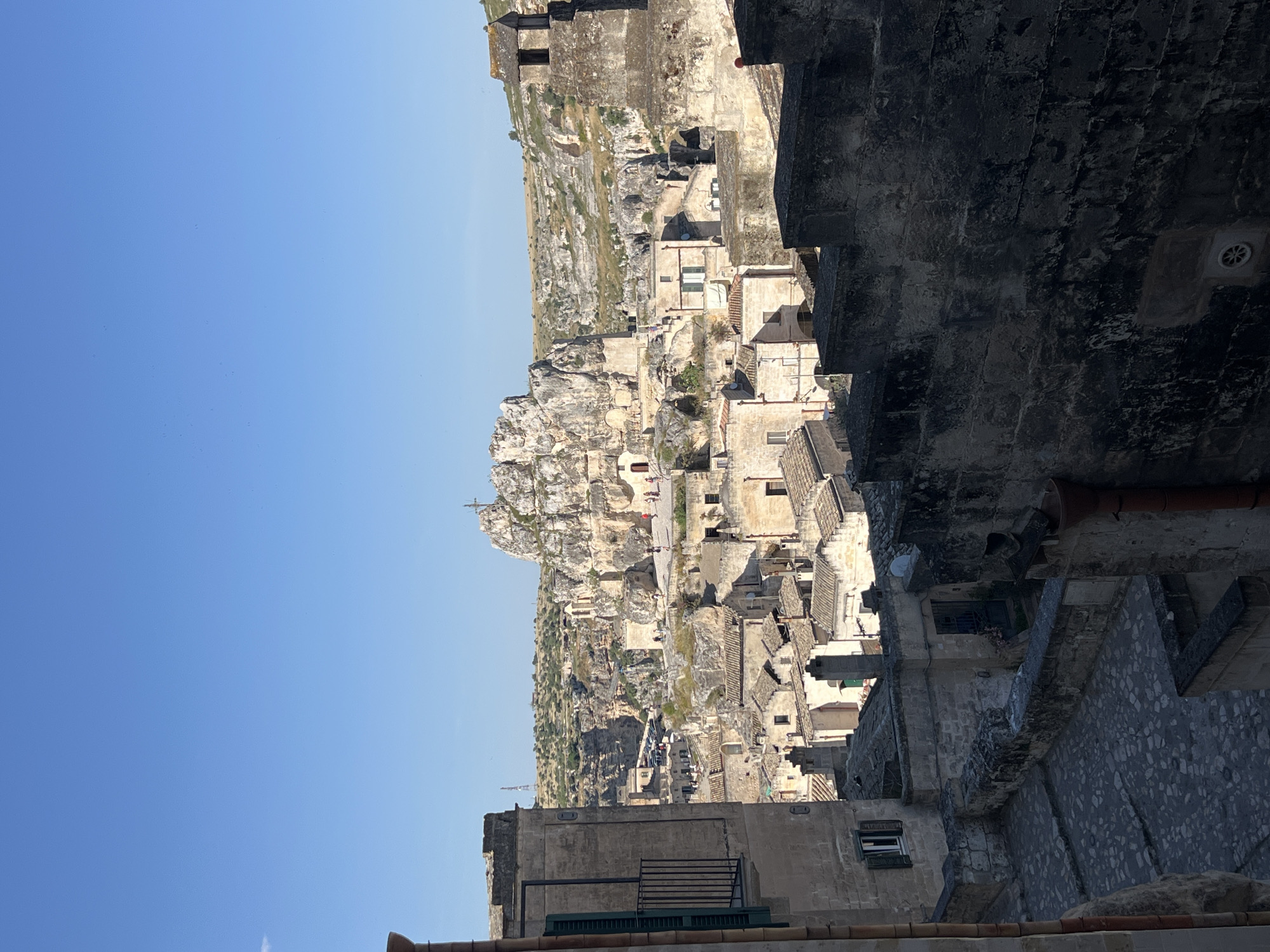 Tourist documents casual bread shopping, sightseeing in historic Matera district
