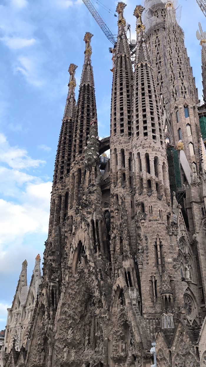 Tourist activity documented around Barcelona's Sagrada Familia during evening hours