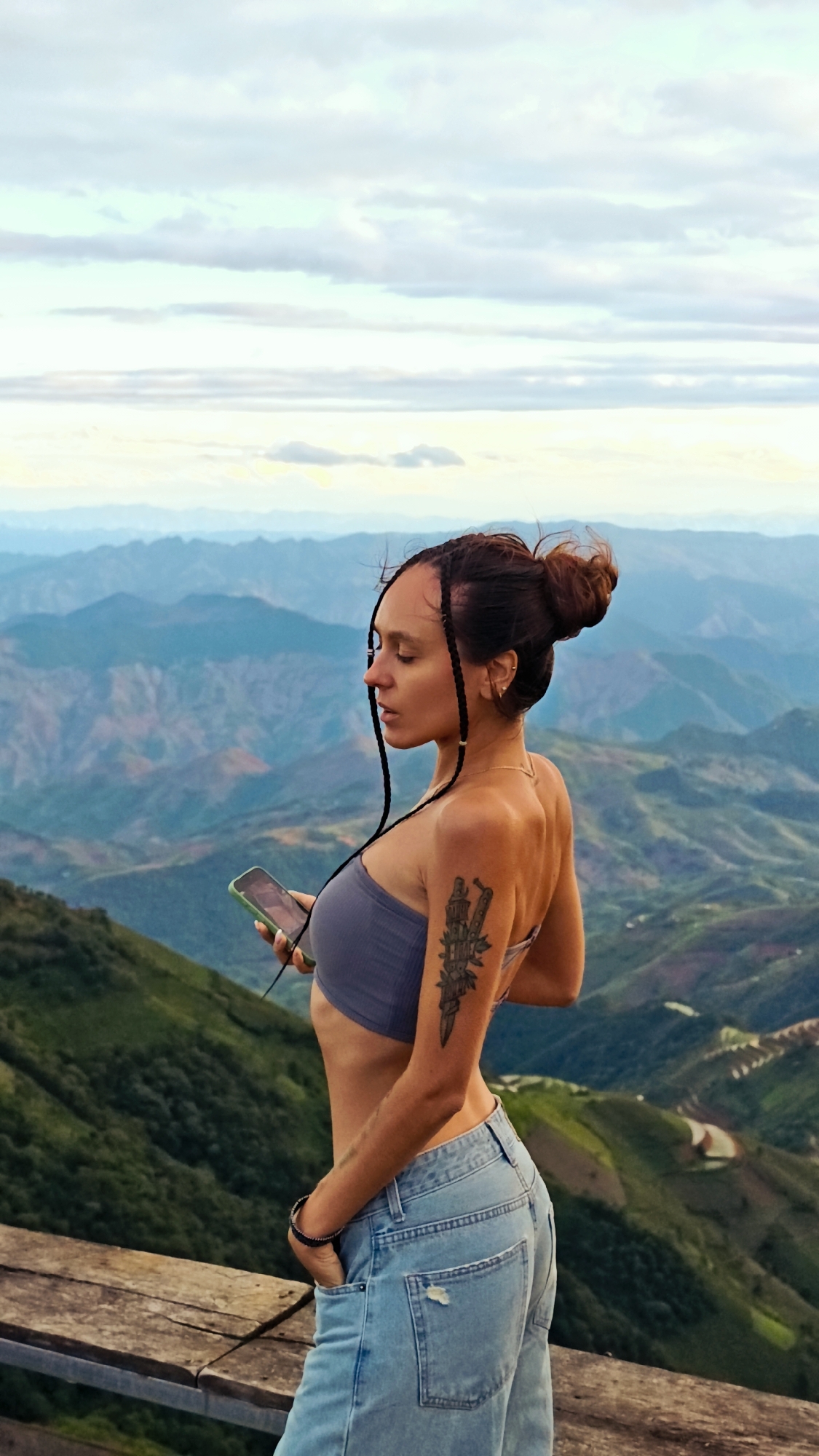 Tourists photograph scenic mountain views at Ta Xua observation deck